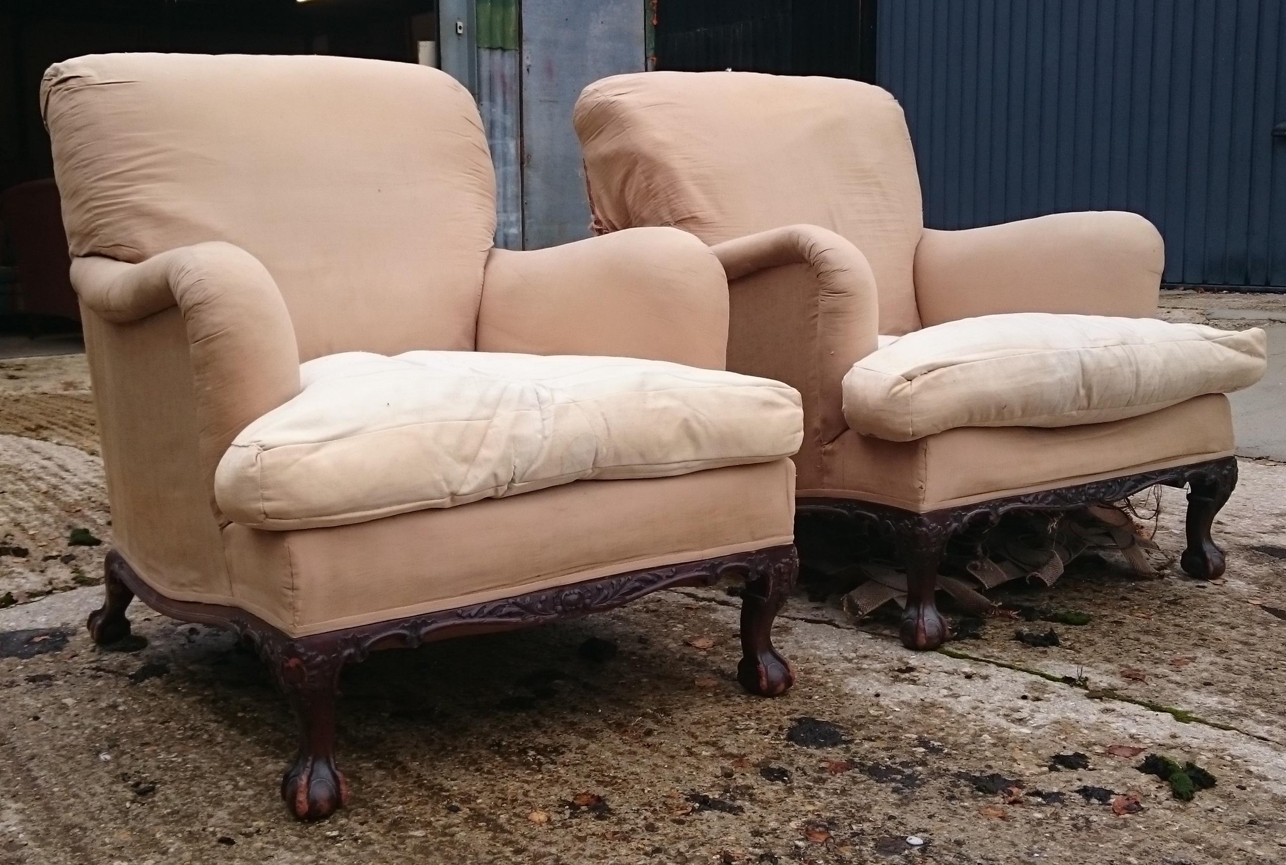 A very rare pair of Howard and Sons chairs standing on ball and claw feet. These chairs are large and comfortable. They are stamped Berners Street which is the earlier and most desirable period for these comfortable chairs. There is some writing on