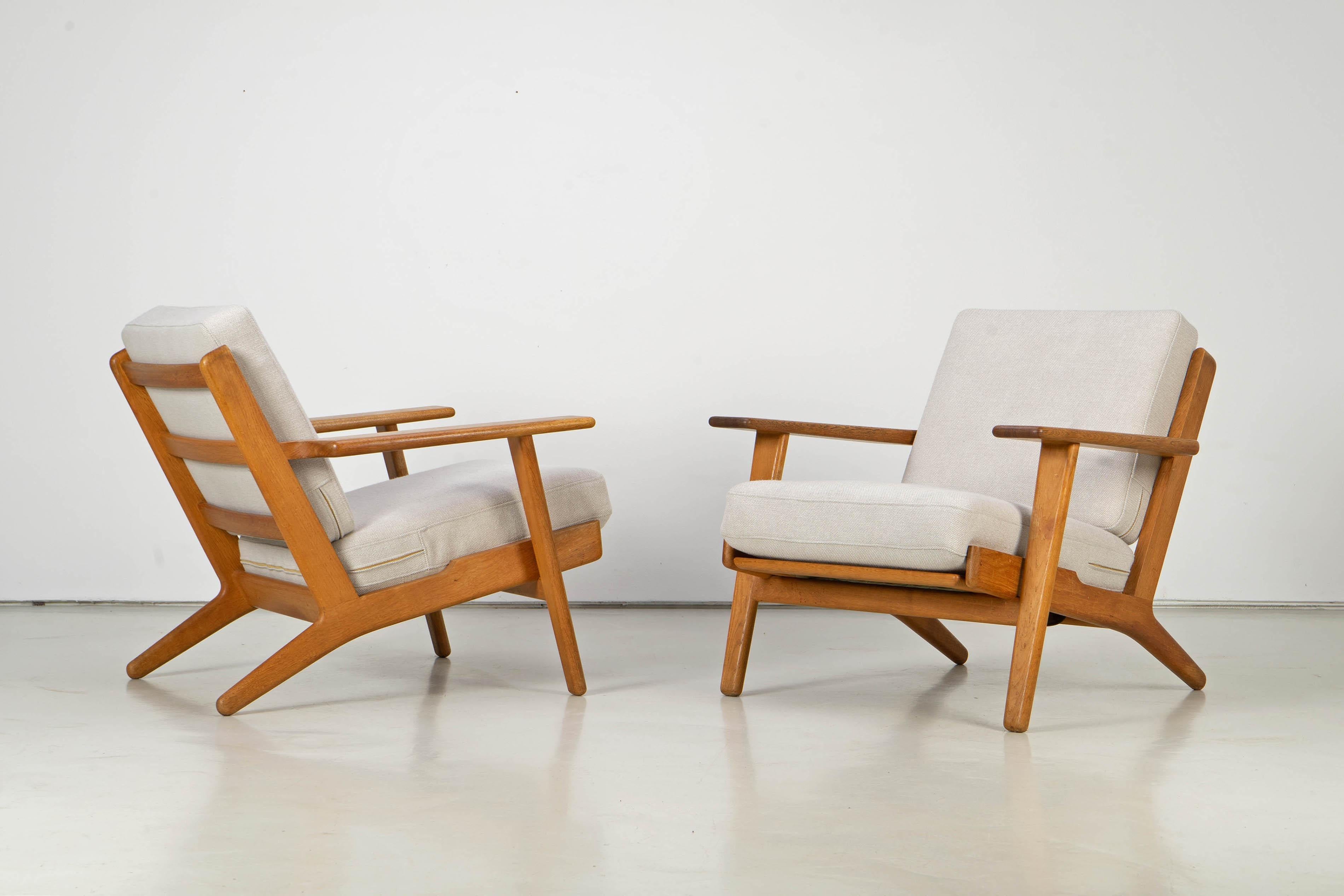 Oak wood easy chairs designed by Hans Wegner for GETAMA, Denmark. The chairs havee been newly upholstered with 