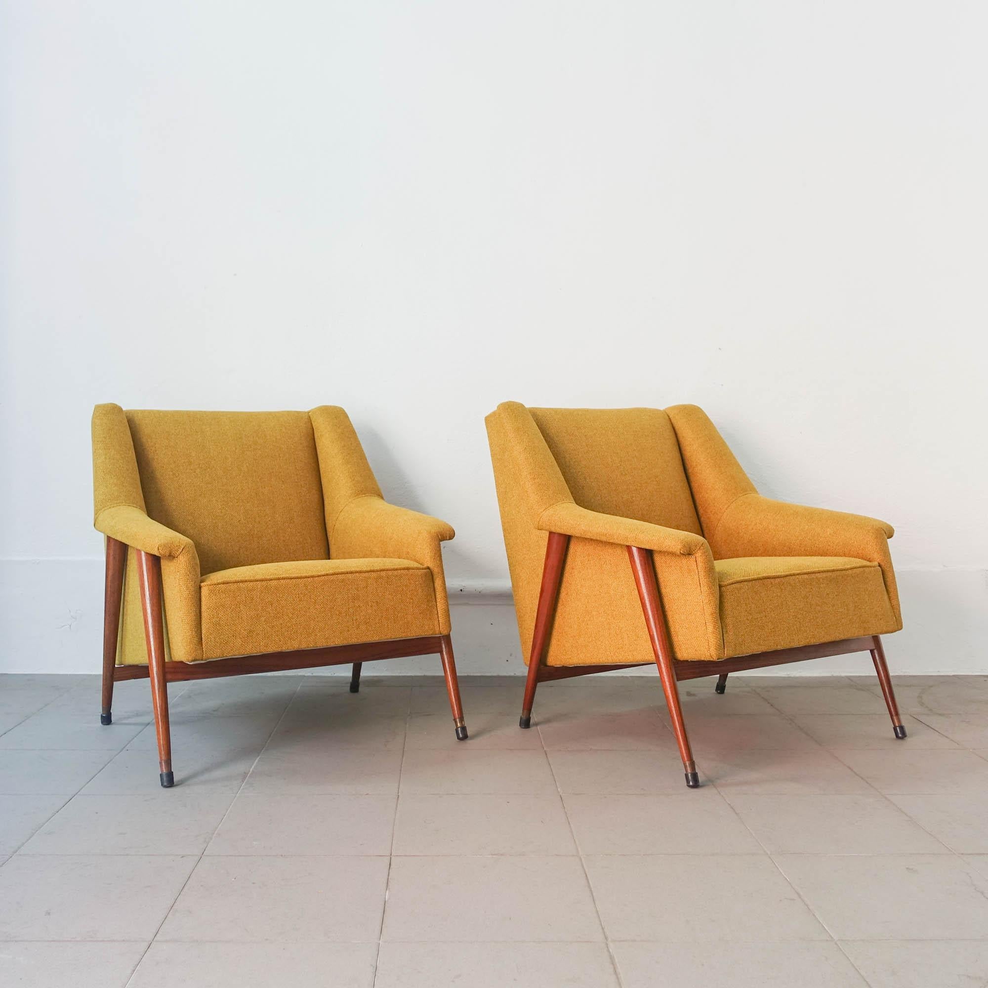 This pair of Easy chairs was designed by José Espinho for Olaio, in Portugal in 1959. The wood structure was fully restored and in one of the armchairs is solid sucupira wood and the other in solid undianuno wood. They have clean and elegant lines.