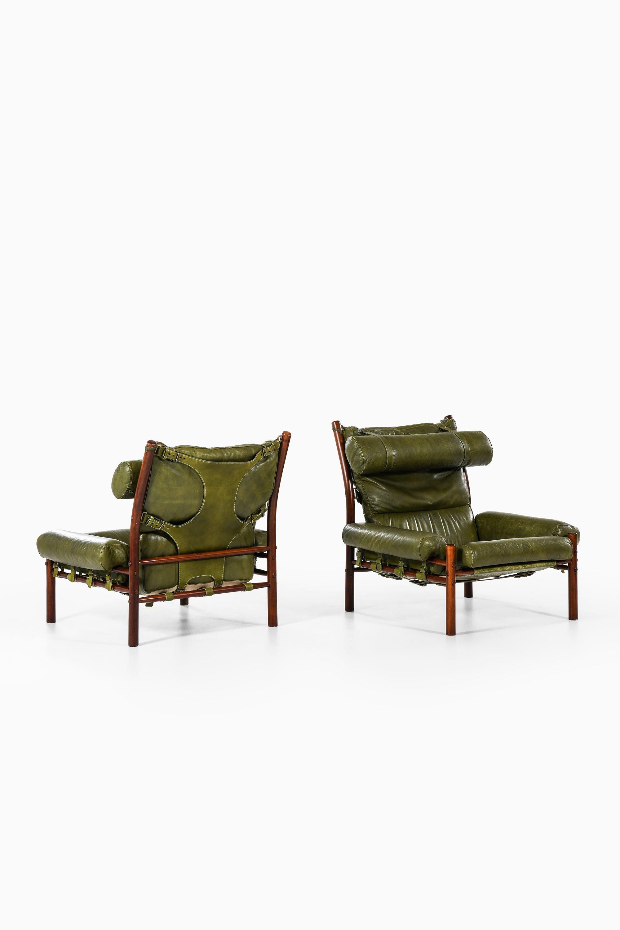 Pair of Easy Chairs in Beech, Green Leather and Brass by Arne Norell, 1960s

Additional Information:
Material: Dark stained beech, green leather, brass
Style: midcentury, Scandinavia
Pair of easy chairs model Inca
Produced by Arne Norell AB in