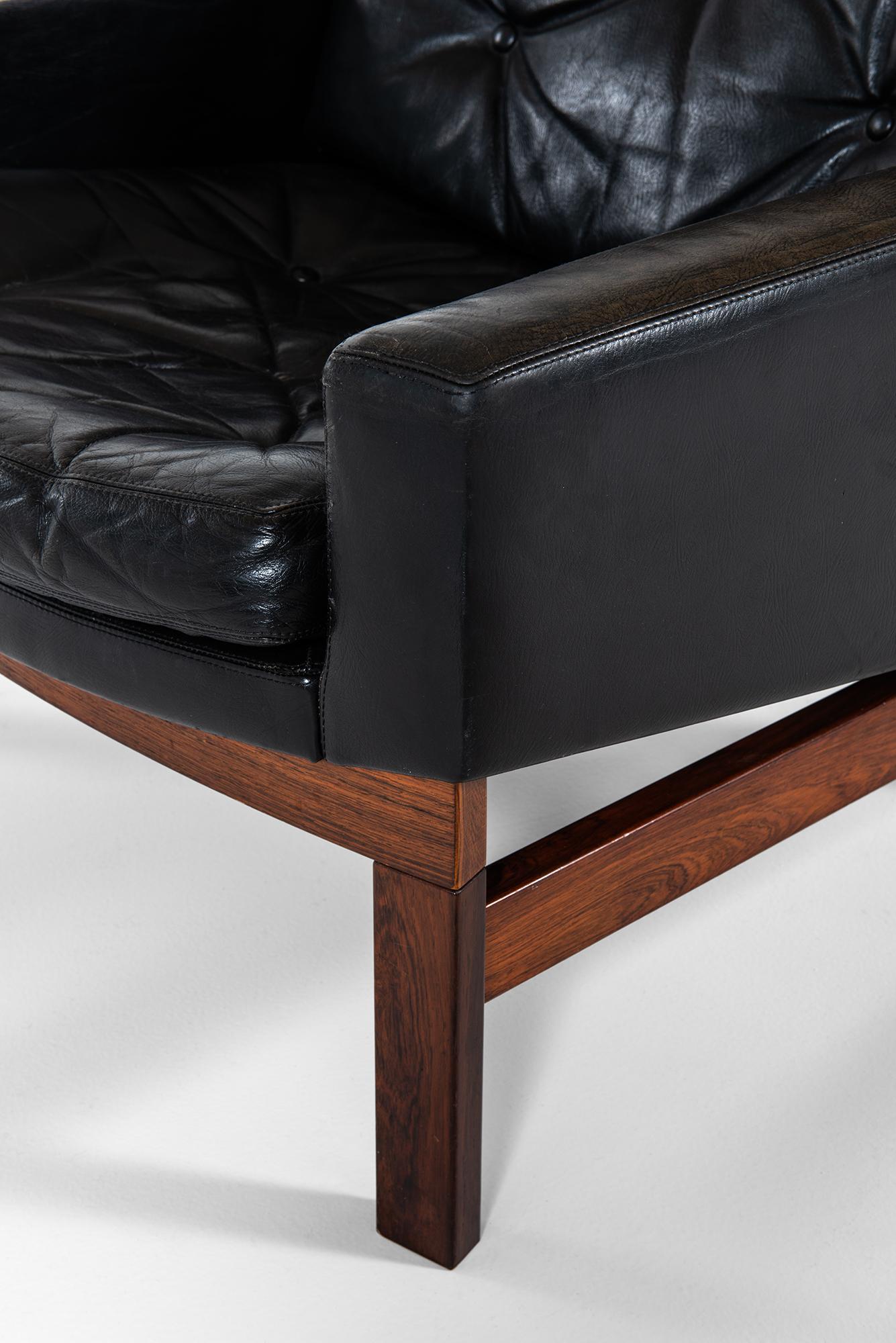 Pair of Easy Chairs in Rosewood and Black Leather Produced in Sweden 1