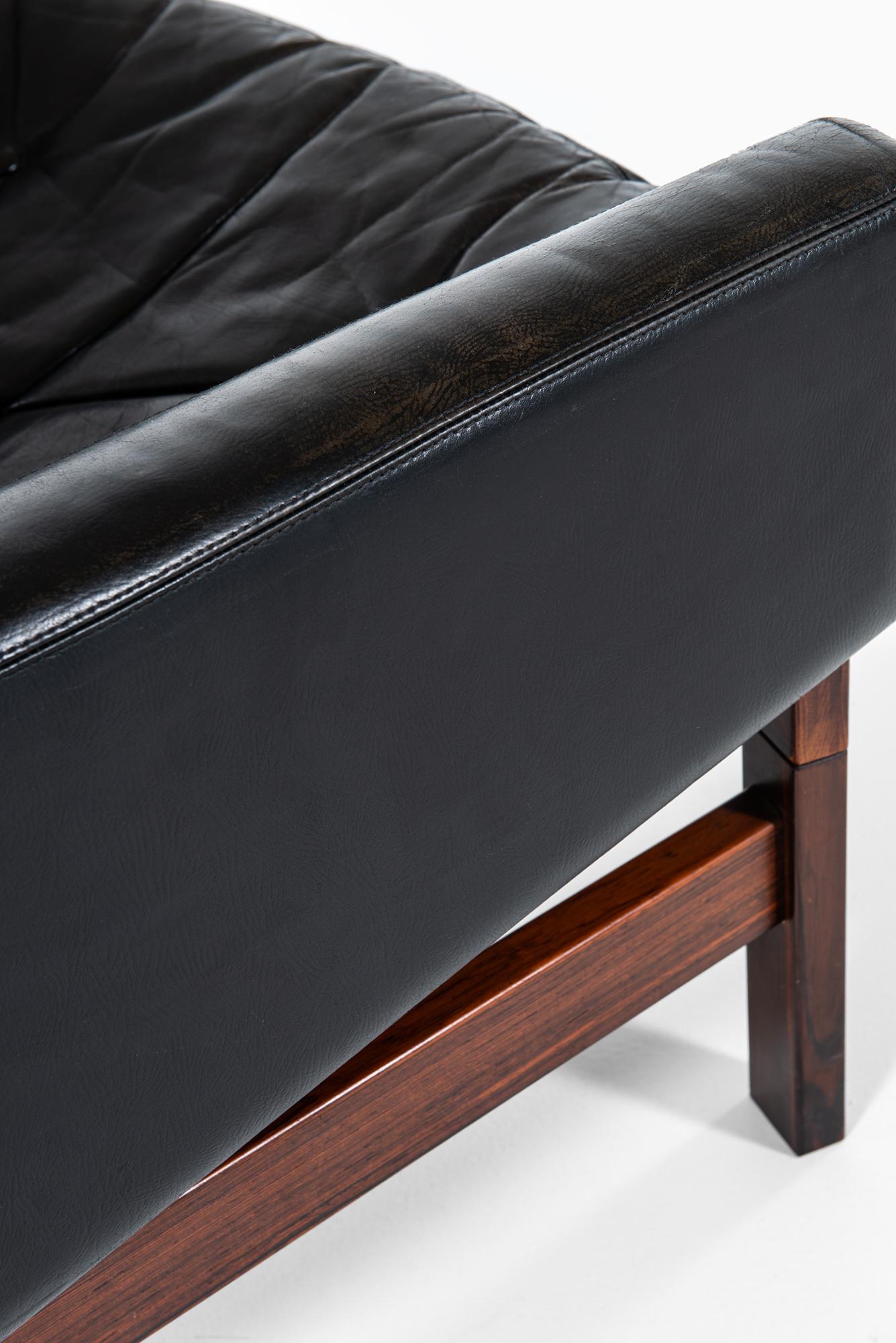 Pair of Easy Chairs in Rosewood and Black Leather Produced in Sweden 2