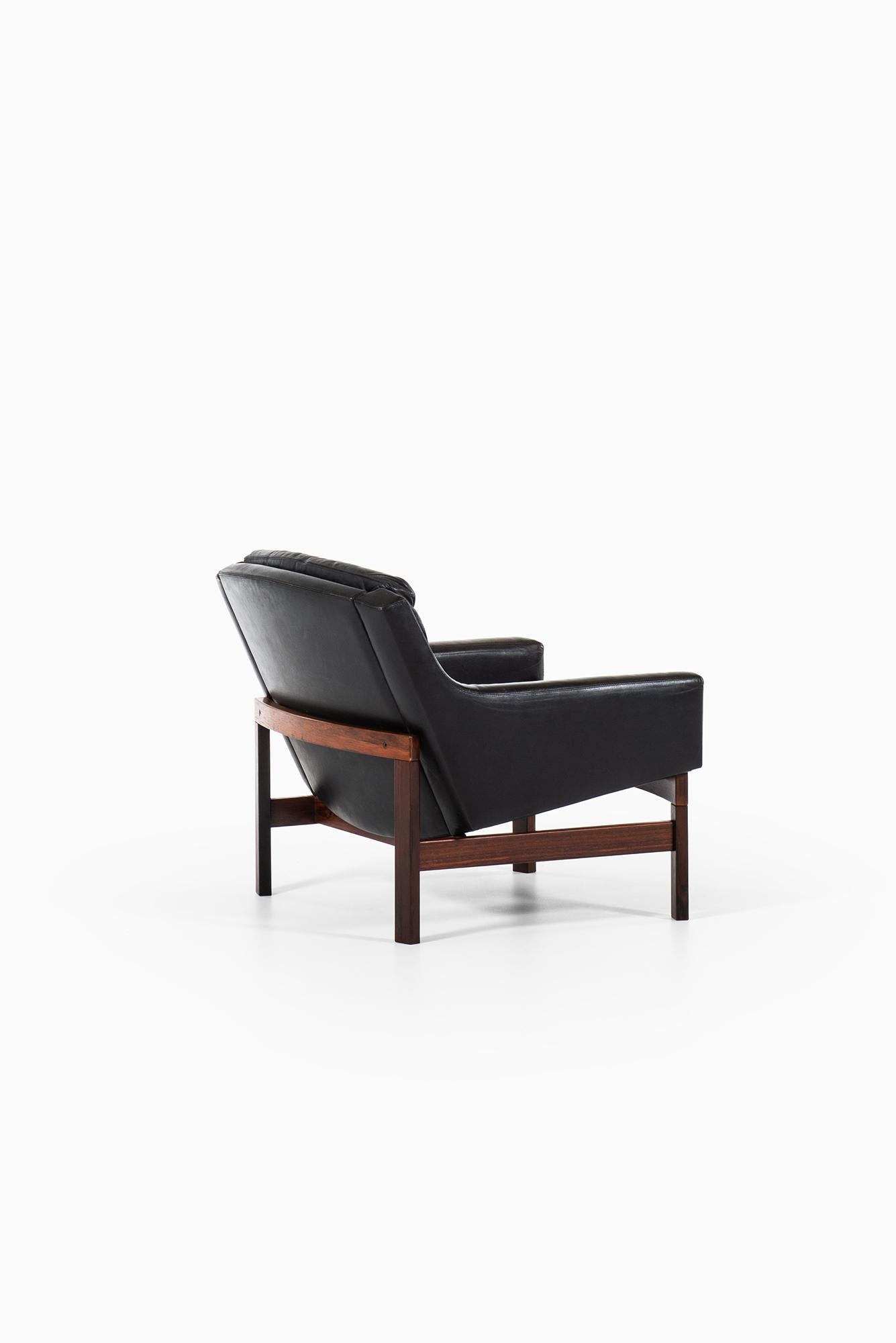 Pair of Easy Chairs in Rosewood and Black Leather Produced in Sweden 3