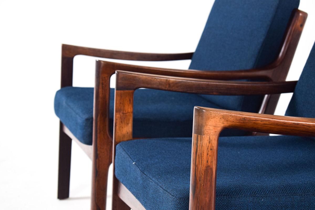 A nice Ole Wanscher pair of easy chairs, manufacture by France & Son. This chairs are constructed out of solid rosewood with sculpted armrests. The joinery is high quality and the beauty that Wanscher put into his work. The chair is super