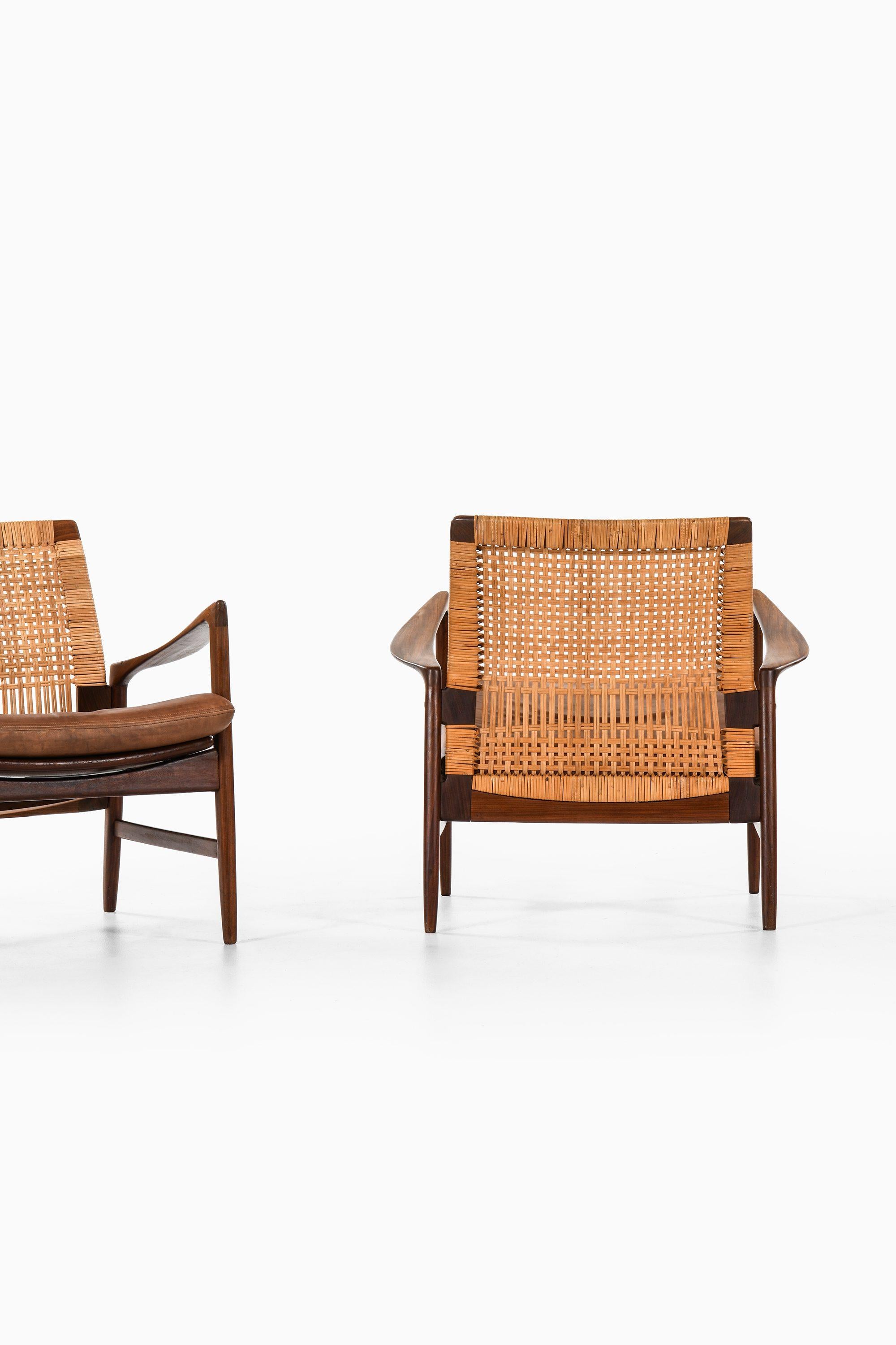 Scandinavian Modern Pair of Easy Chairs in Teak, Cane with Brown Leather by Ib Kofod-Larsen, 1950s