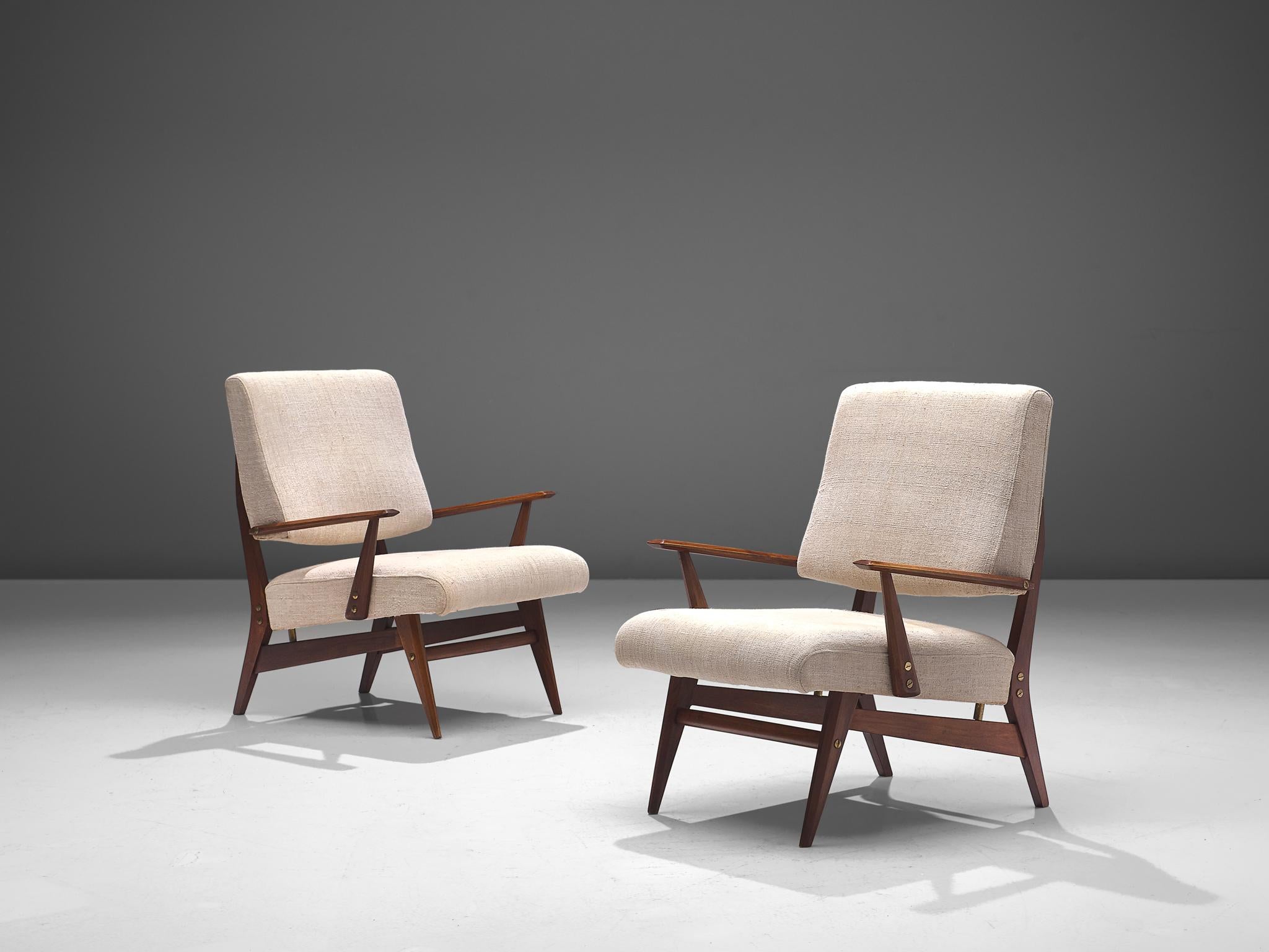 Easy chairs, in eggshell white fabric, walnut and brass, Italy, 1960s.

These mid-modern armchairs are executed in a neutral, off-white fabric. The comfortable easy chairs show voluptuous, round lines. The most iconic feature of this set is the