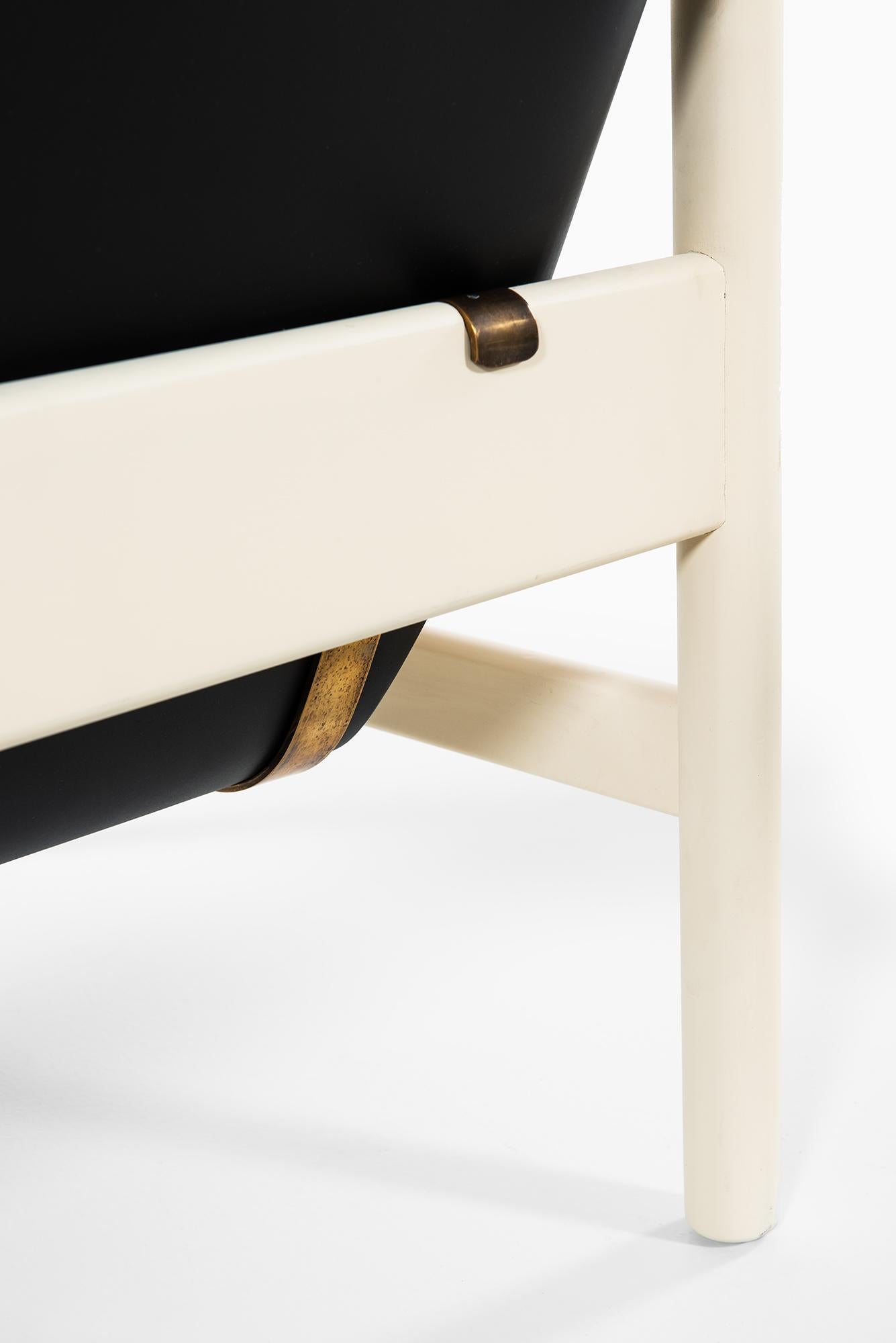 Brass Pair of easy chairs in white and black lacquered wood produced in Denmark For Sale