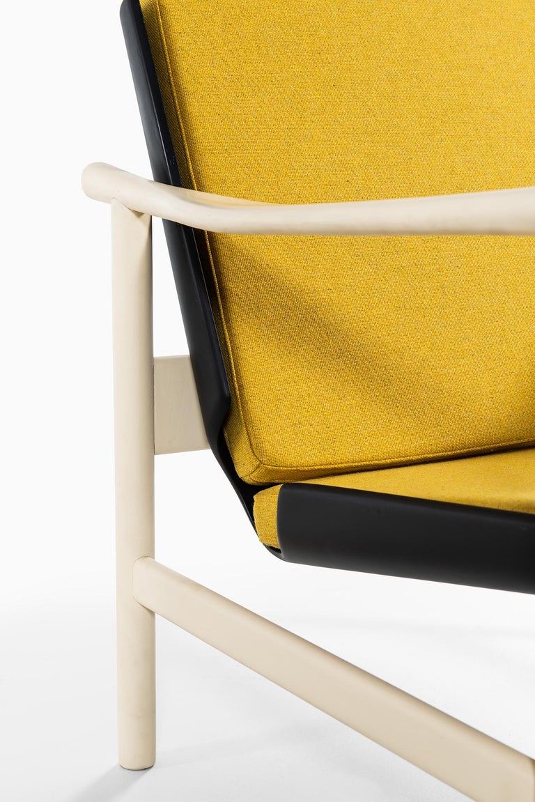 Pair of easy chairs in white and black lacquered wood produced in Denmark For Sale at 1stDibs