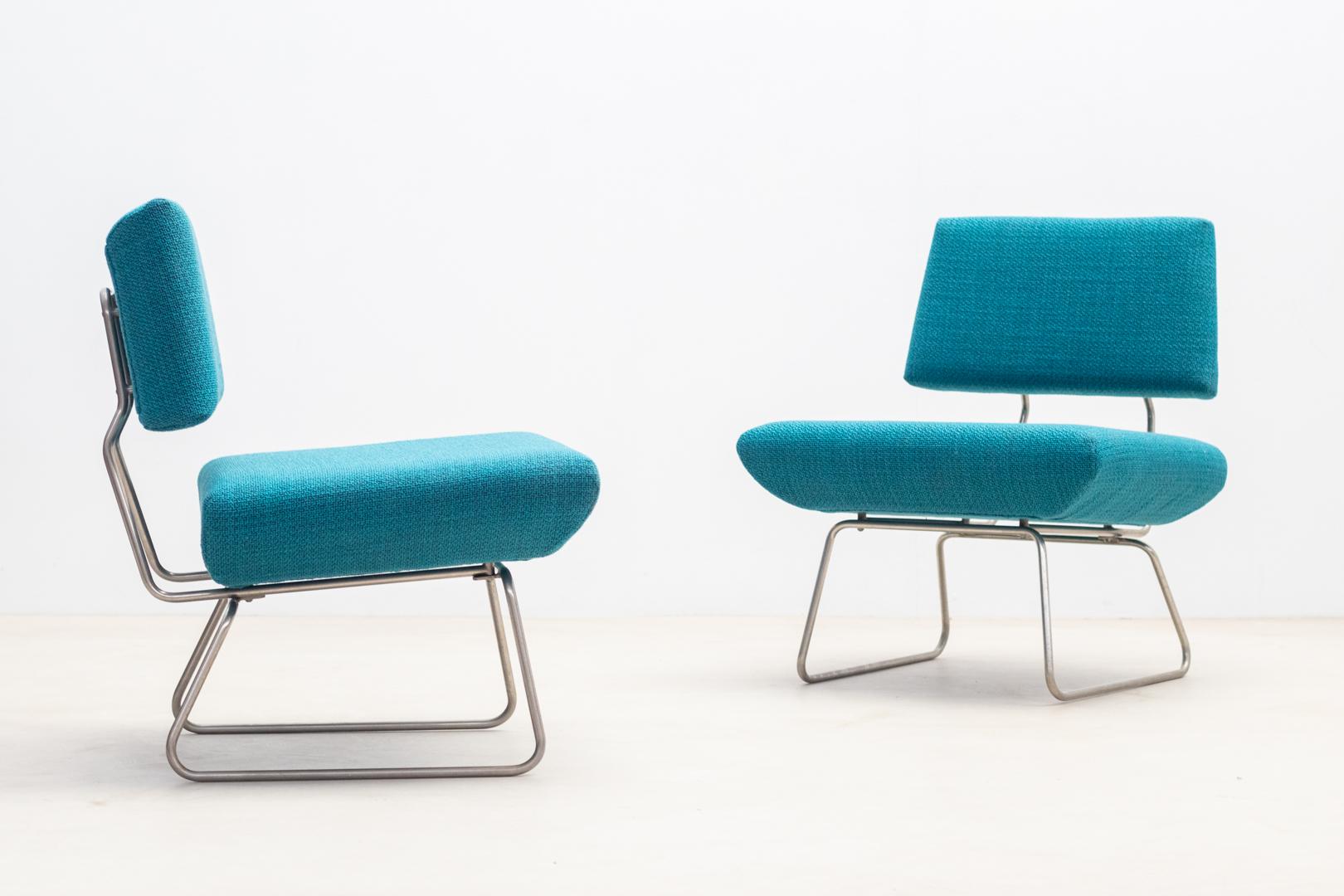 Pair of low armchairs with clean lines  by Georges Coslin produced by Trevi Spa in the 1960s
These armchairs feature a distinctive metal tubular structure that is provides durability and support. 
The seats and backrests of these armchairs are