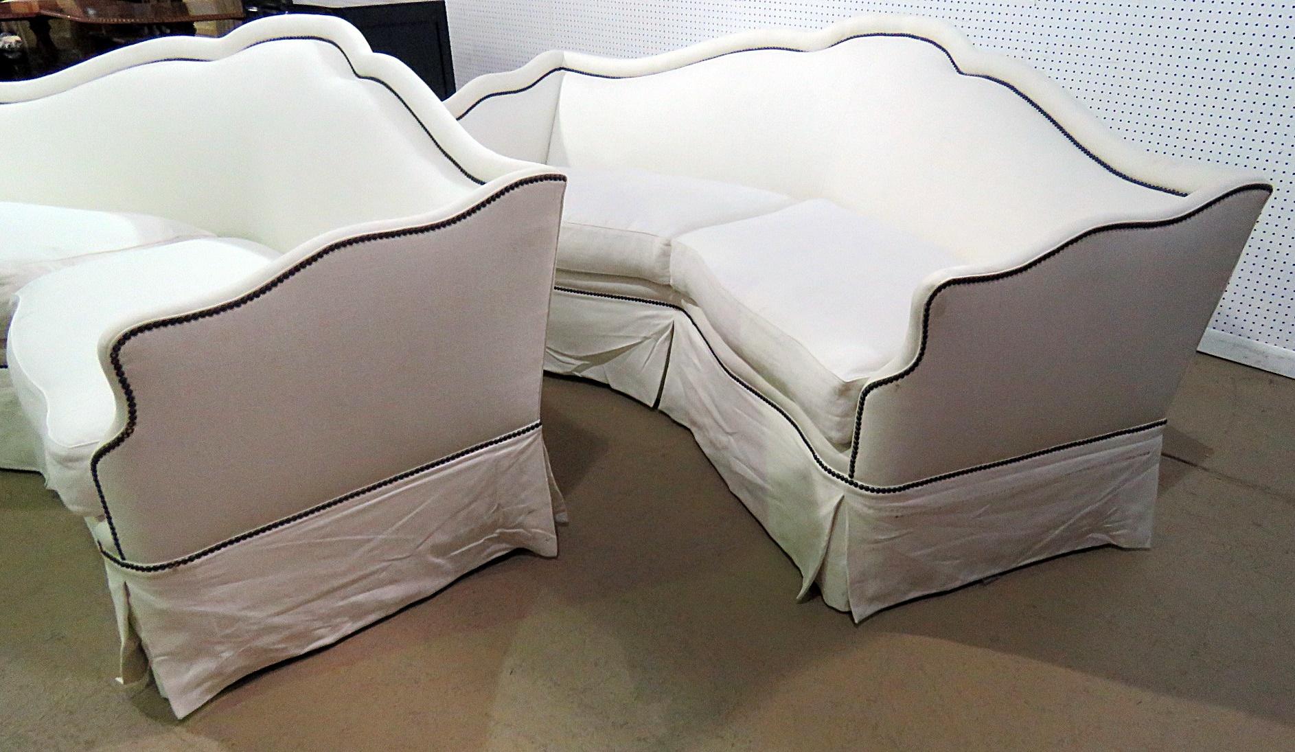 Pair of Ebanista modern settees with linen upholstery and nailhead trim.
