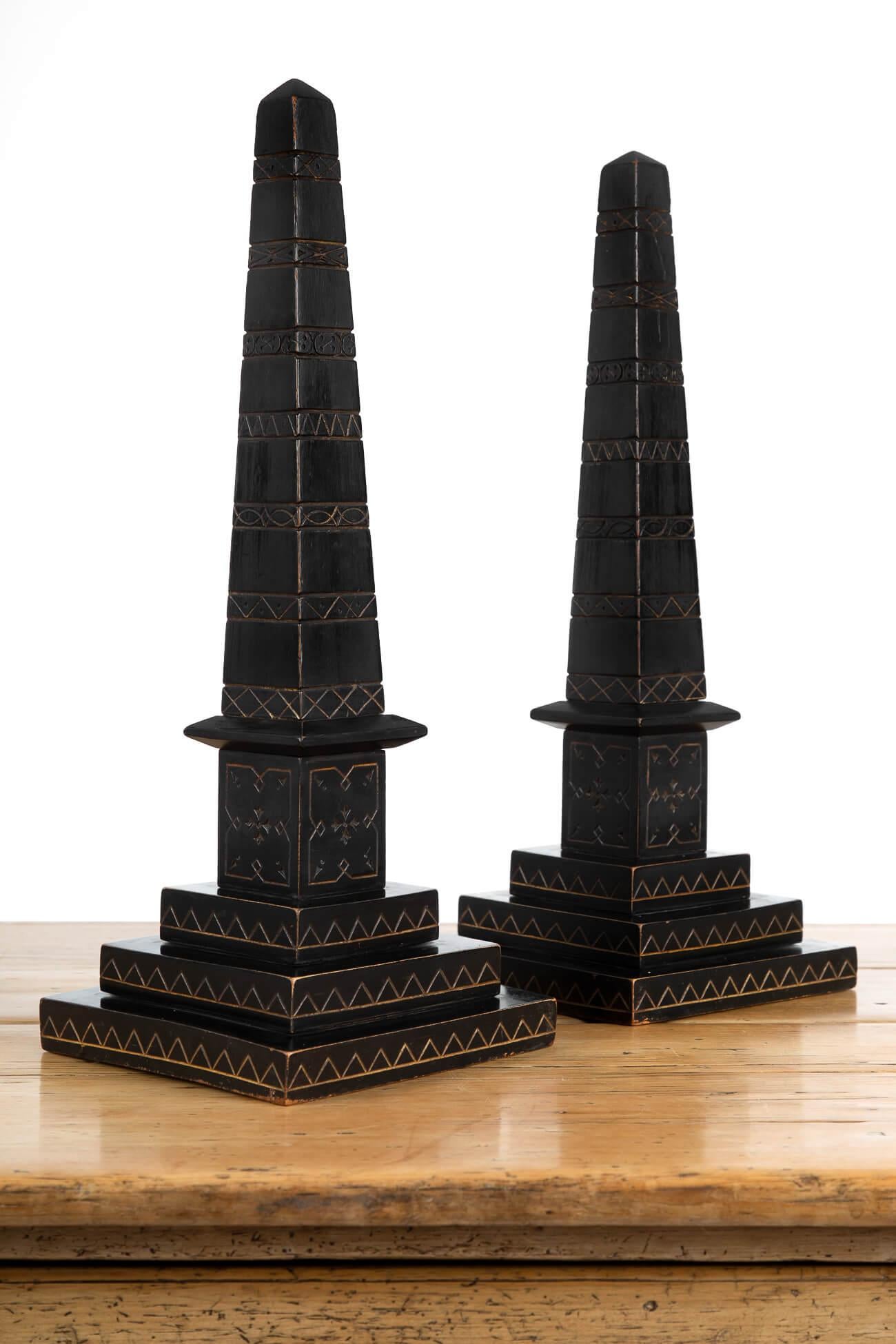 A pair of incise-carved ebonised library obelisks with stepped square bases. Picked out in gilt and in the Aesthetic Movement style of the mid-late 19th century. Acquired from a gentleman’s library. Price is for the pair. 
British, circa