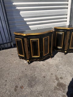 Pair of Ebonized and gilt Demi lune Cabinets