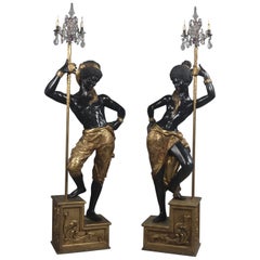 Antique Pair of Ebonized and Gilt Figures Supporting Three-Light Candelabra, circa 1920