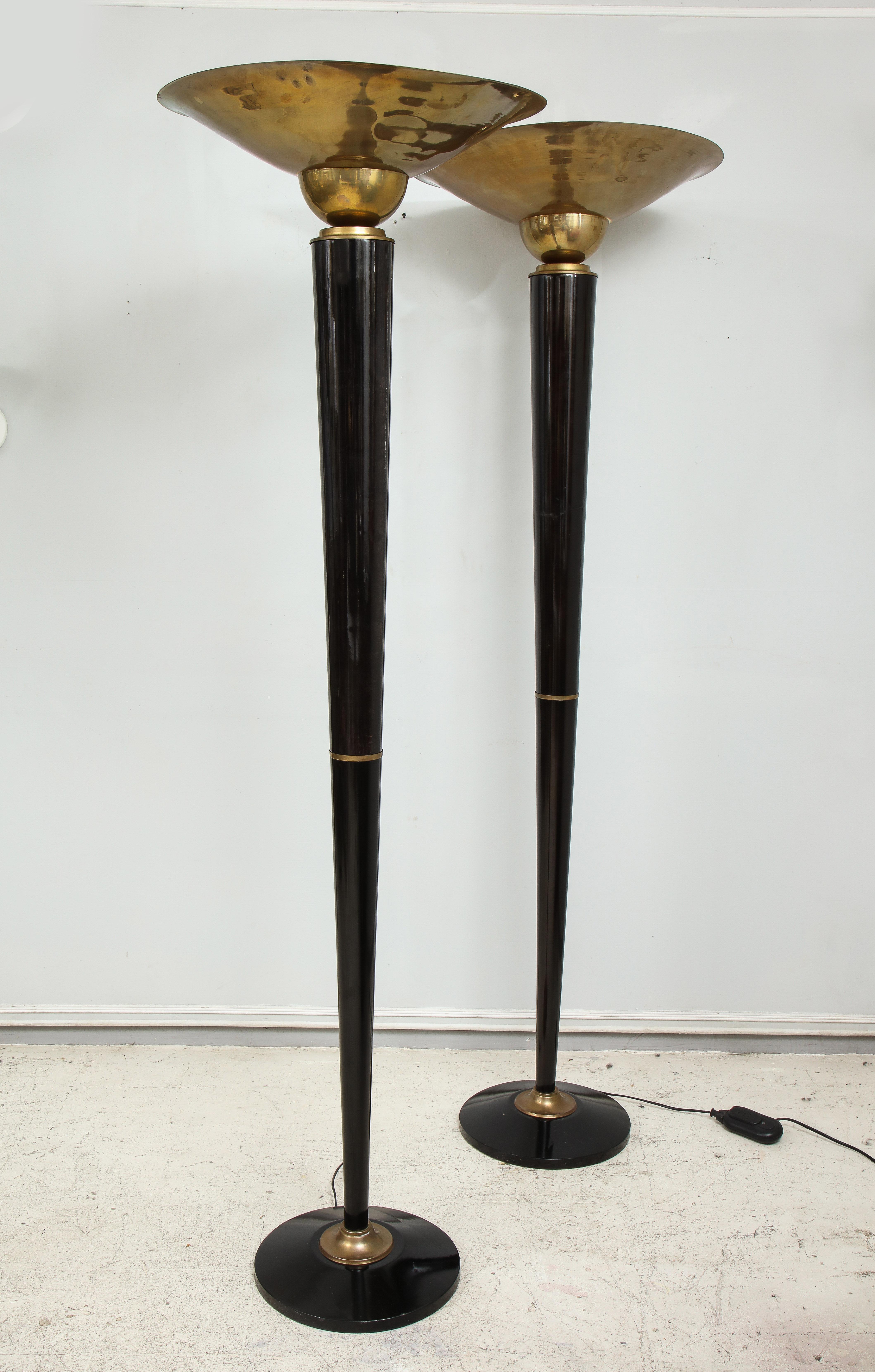 Pair of ebonized brass torchieres/floor lamps in the Art Deco manner.