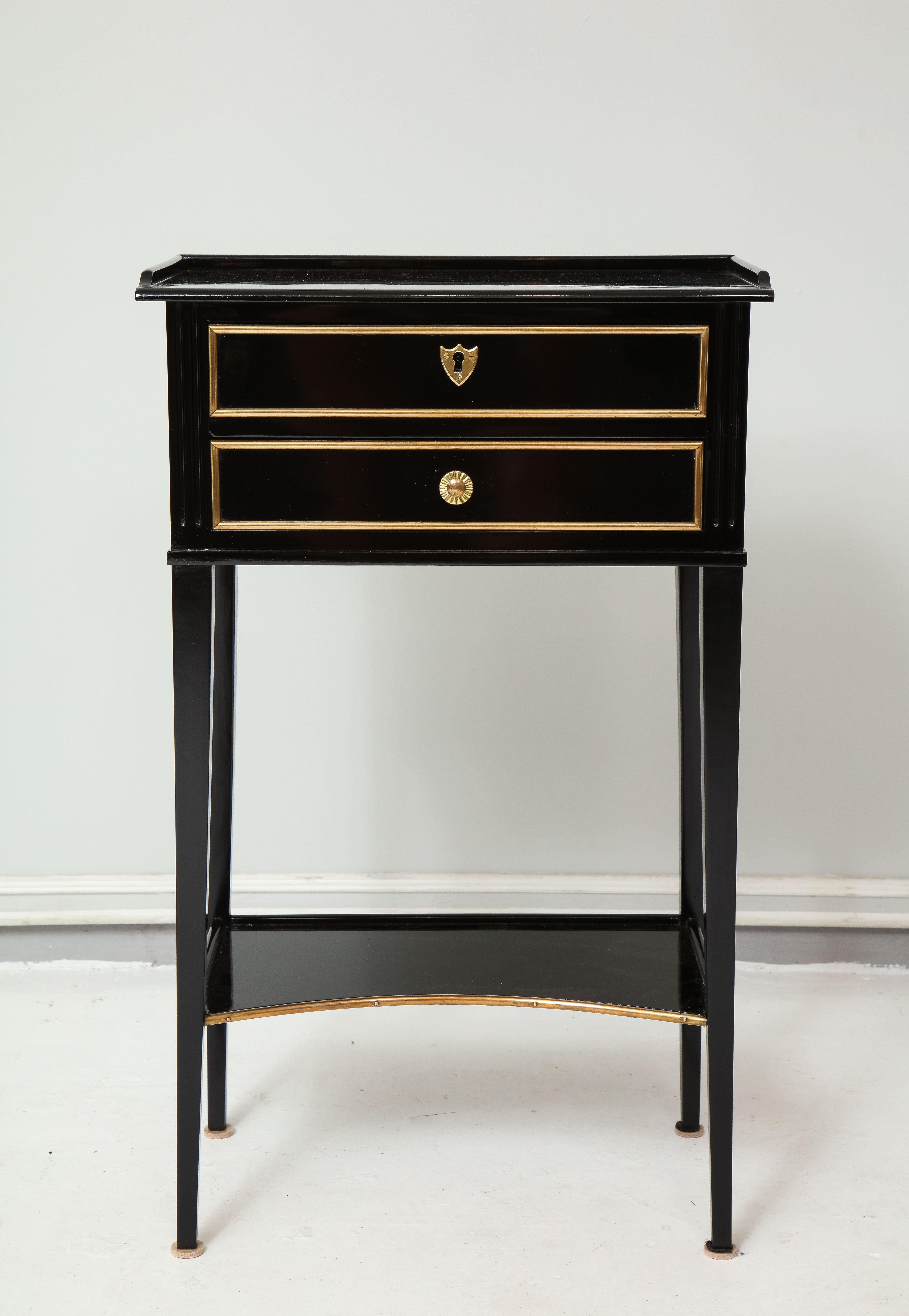 Pair of ebonized Directoire style end tables/ nightstands with bronze trimming and two drawers.