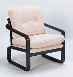 Pair of ebonized French open armchairs recently upholstered in Boucle fabric.