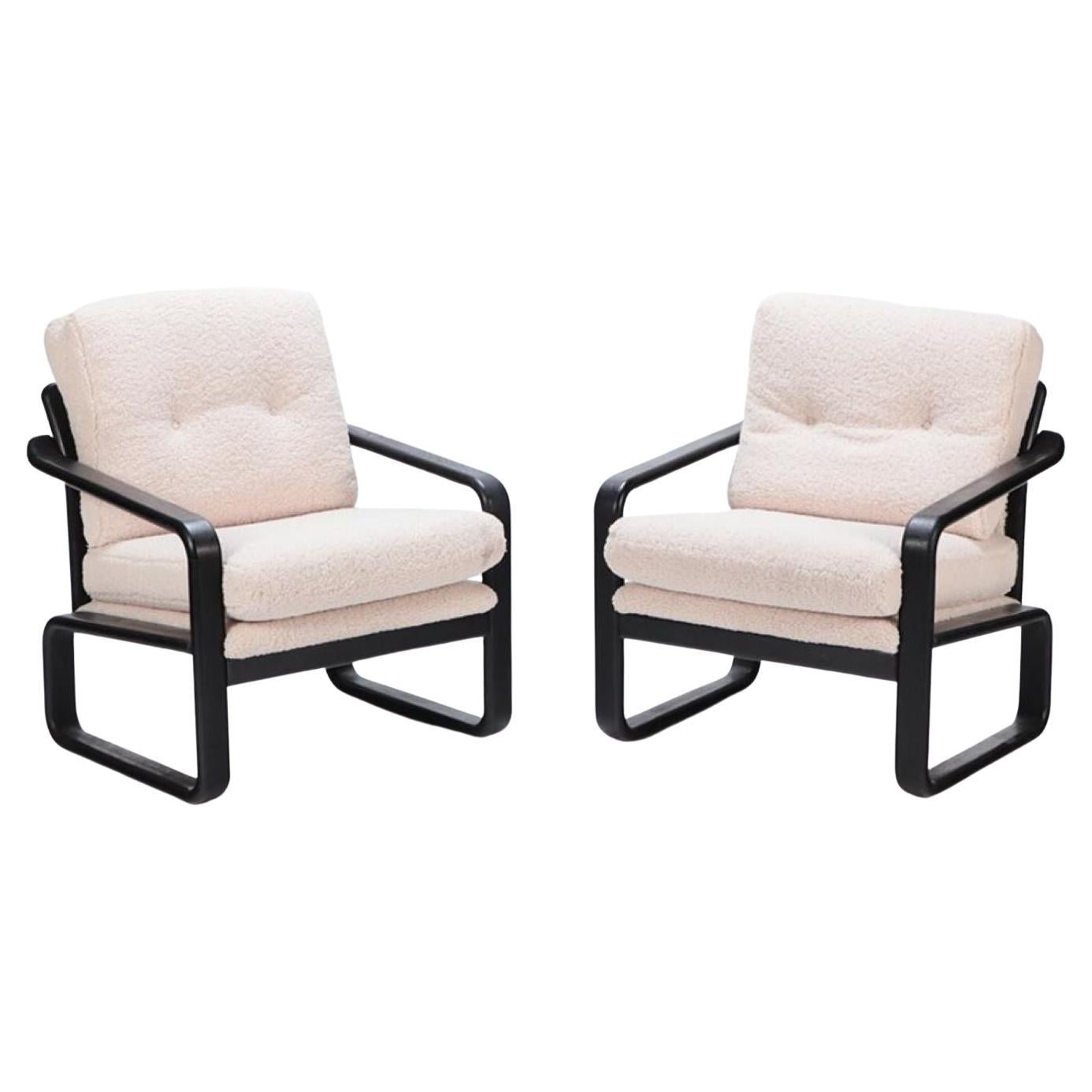 Pair of ebonized French open armchairs recently upholstered in Boucle fabric. For Sale