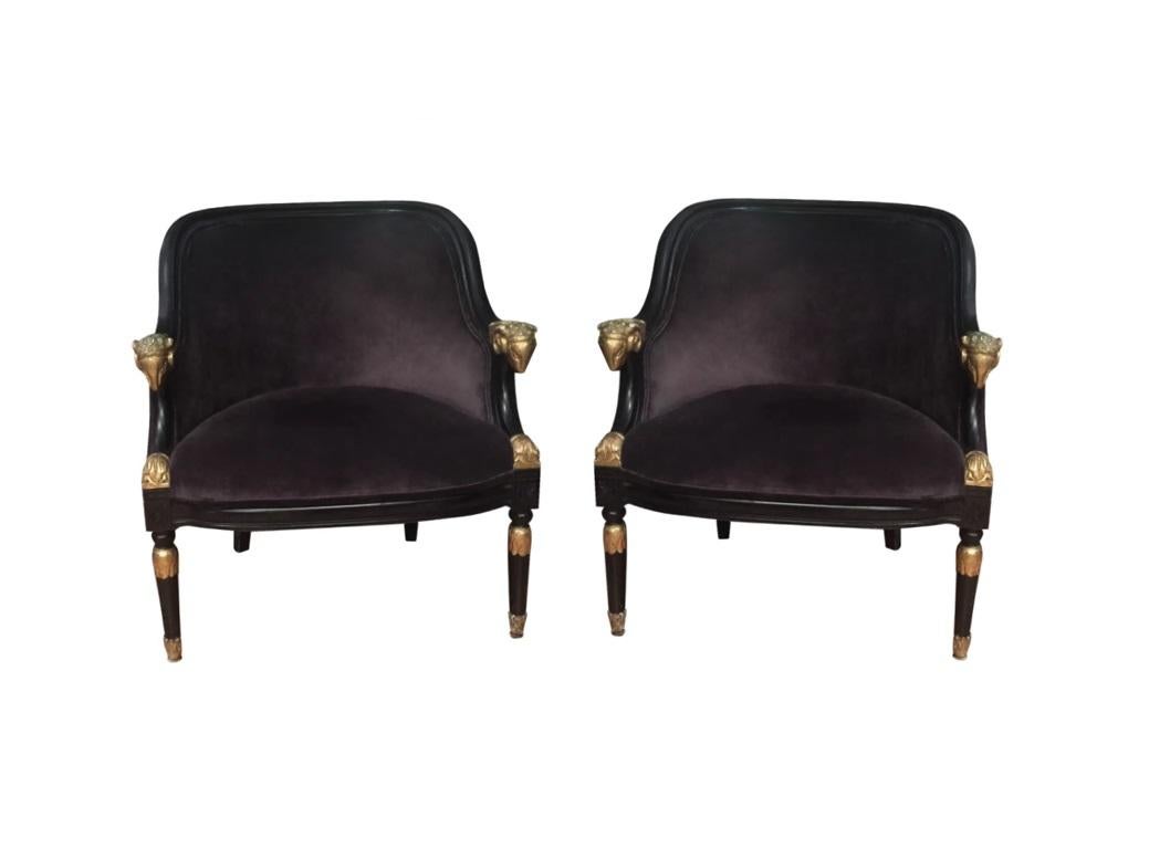 Hollywood Regency Pair of Ebonized & Gilt Bergère Chairs with Carved Ram Heads For Sale