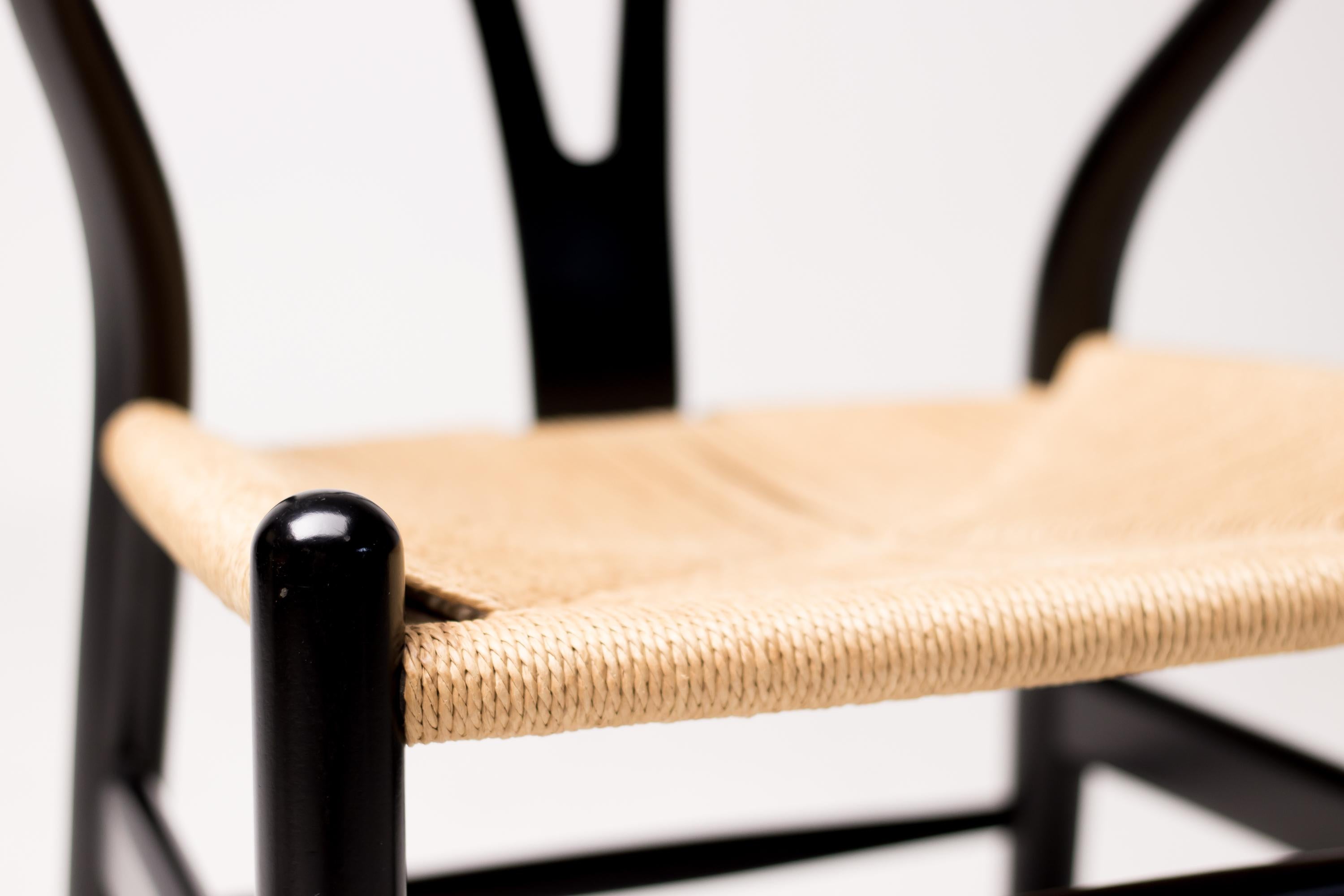 Pair of wishbone dining chairs in black lacquered oak designed by Hans Wegner for Carl Hansen.
Marked.
 