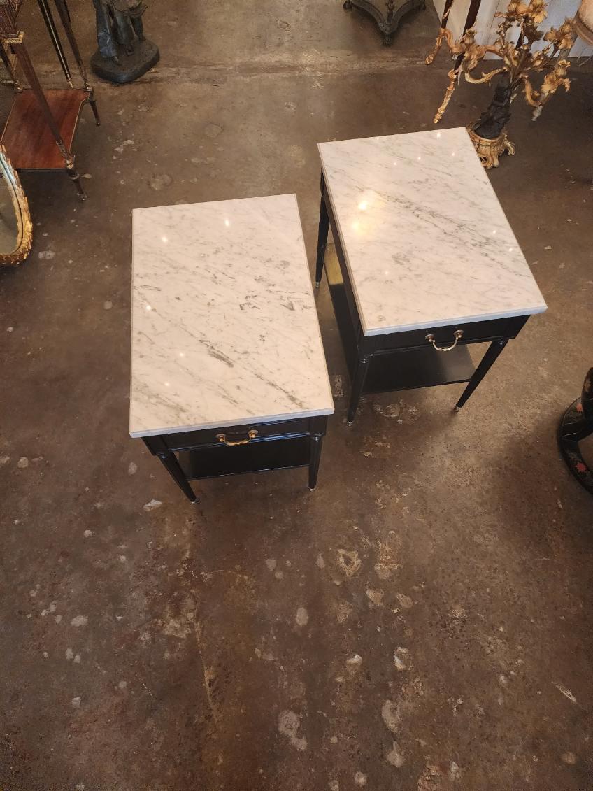 Pair of ebonized marble top  tables with a single drawer in the manner of Andre Arbus Circa 1950