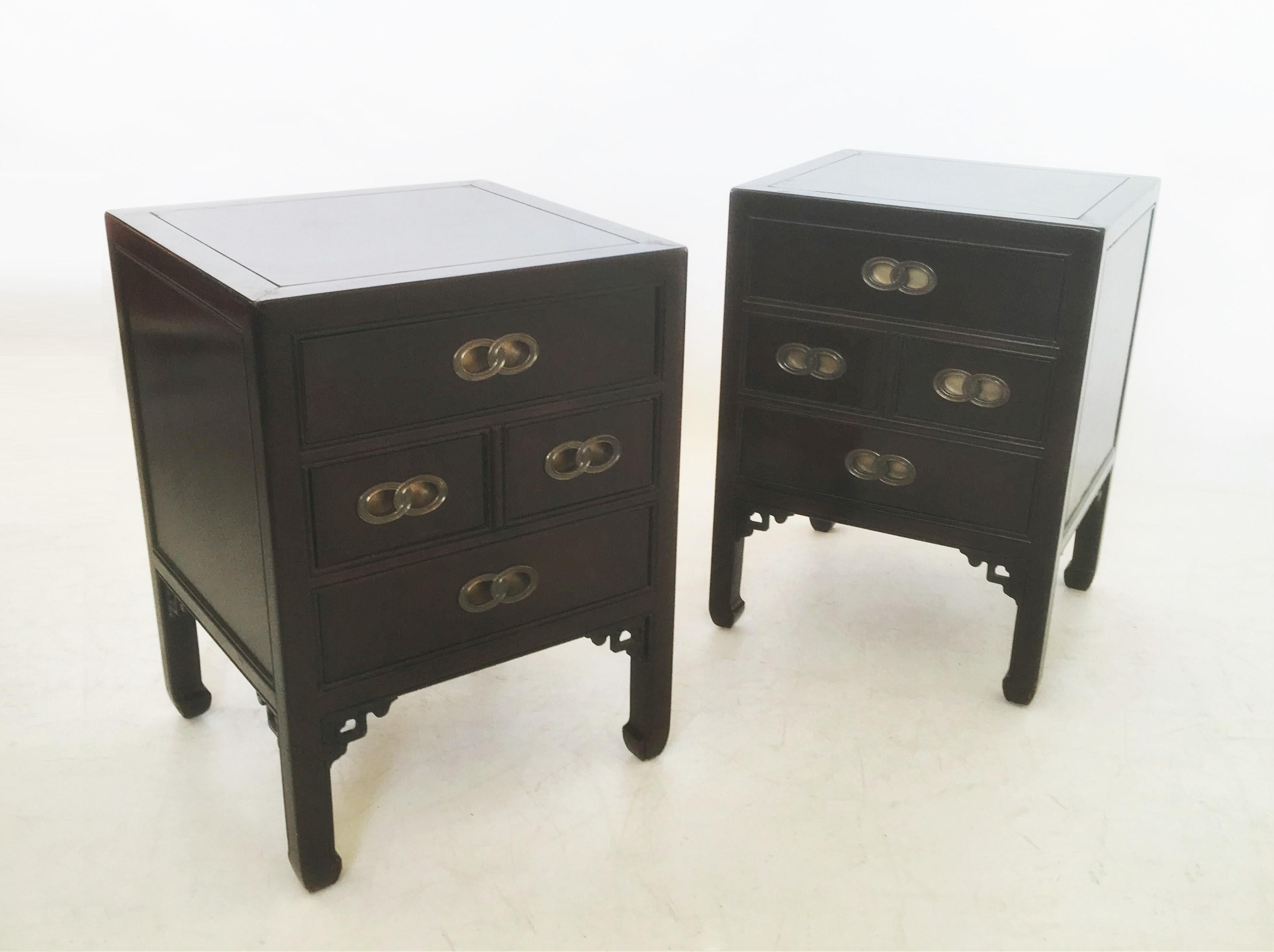 Chinoiserie Asian inspired end tables/nightstands by Michael Taylor for Henredon. Professionally refinished the nightstands are featured in solid wood with an ebonized finish. Conforming case supporting three dovetail drawers with double circle