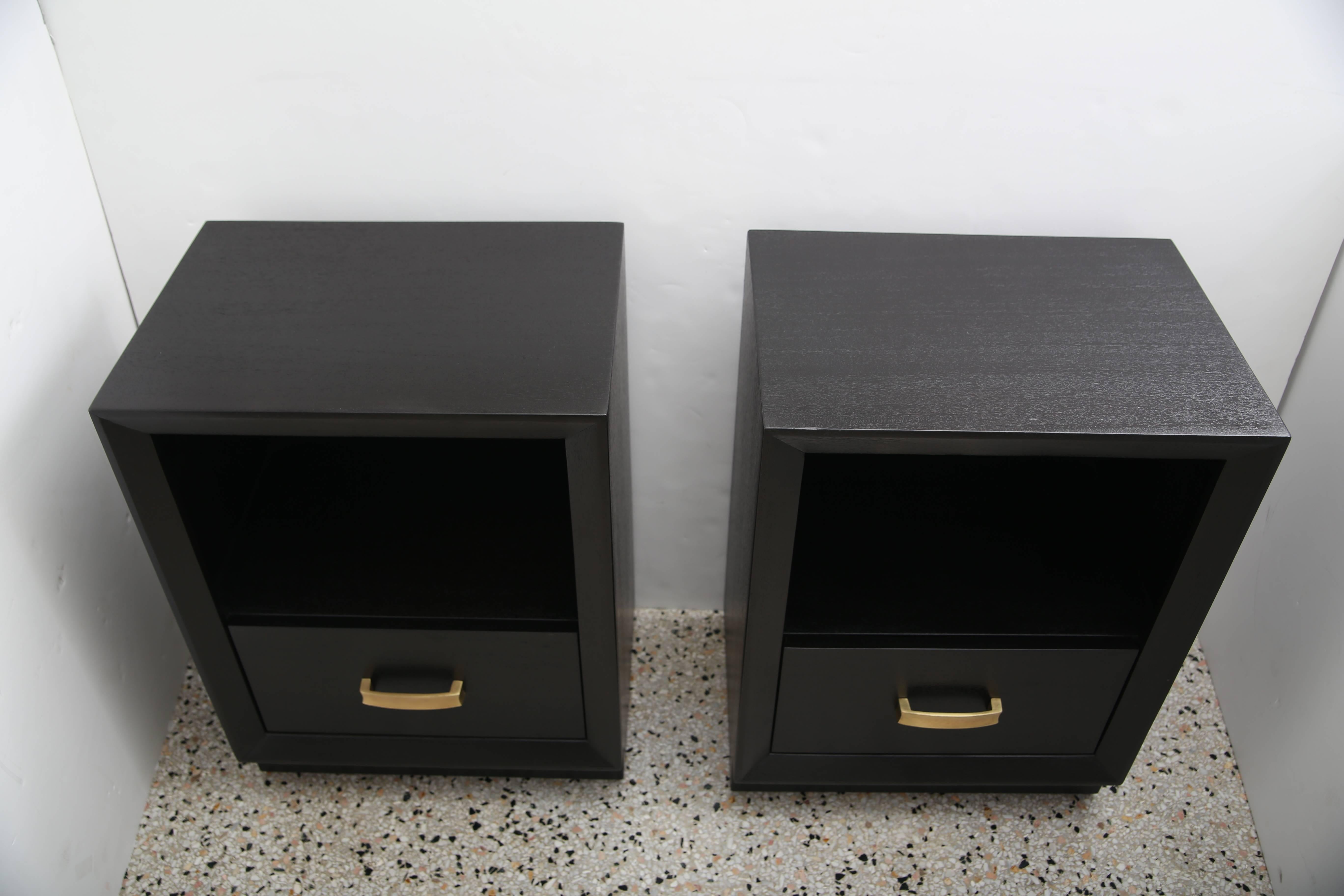 This stylish pair of nightstands have recently been professionally refinished in a dark ebony finish which work beautifully with the grain of the mahogany wood. The simple form handle is fabricated in brass.

Note: Furniture label on drawer