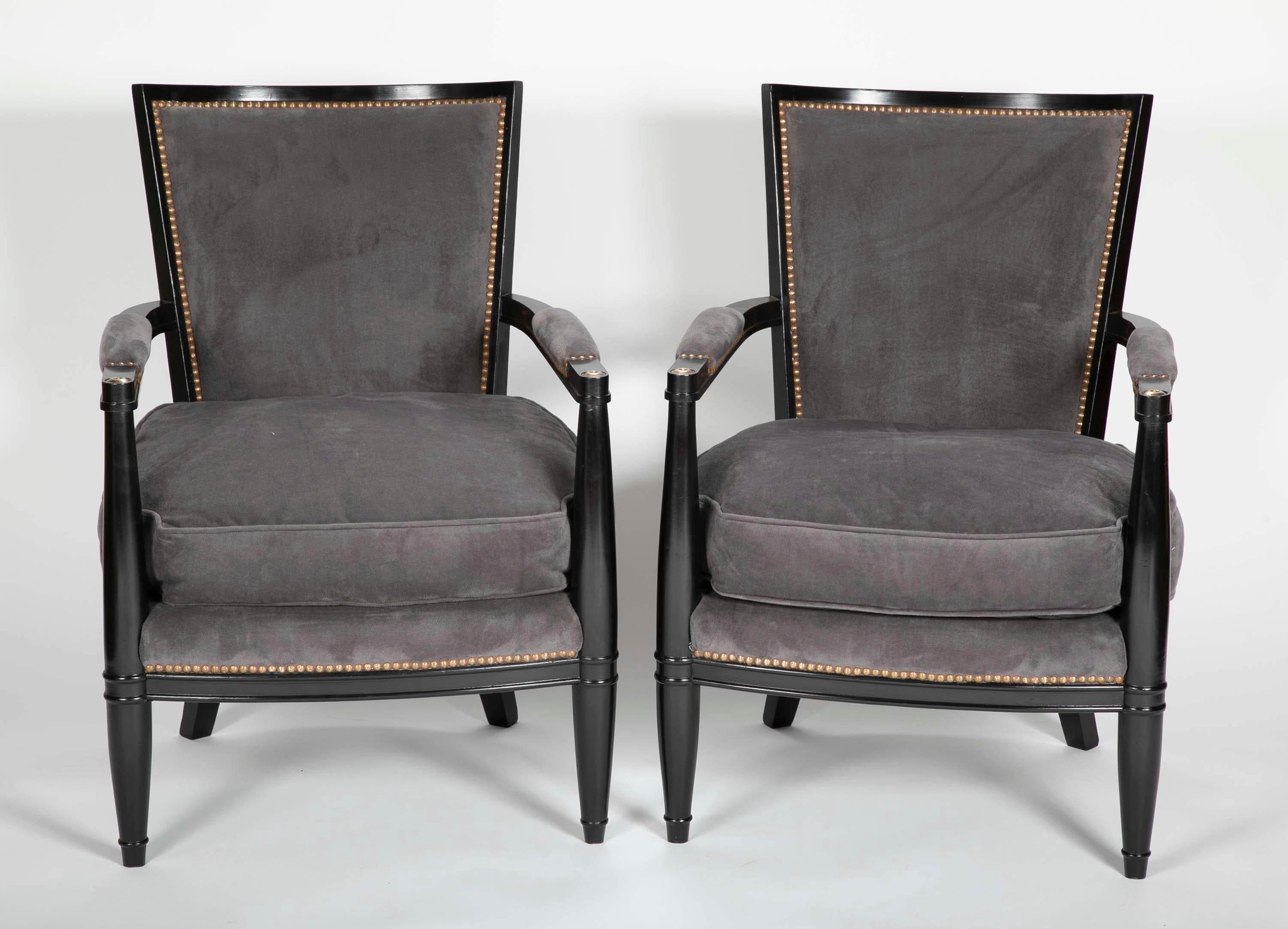 Pair of ebonized open armchairs French Directoire style in the manner of Andre Arbus. Upholstered back and seat cushion. Measure: Seat height 17.5