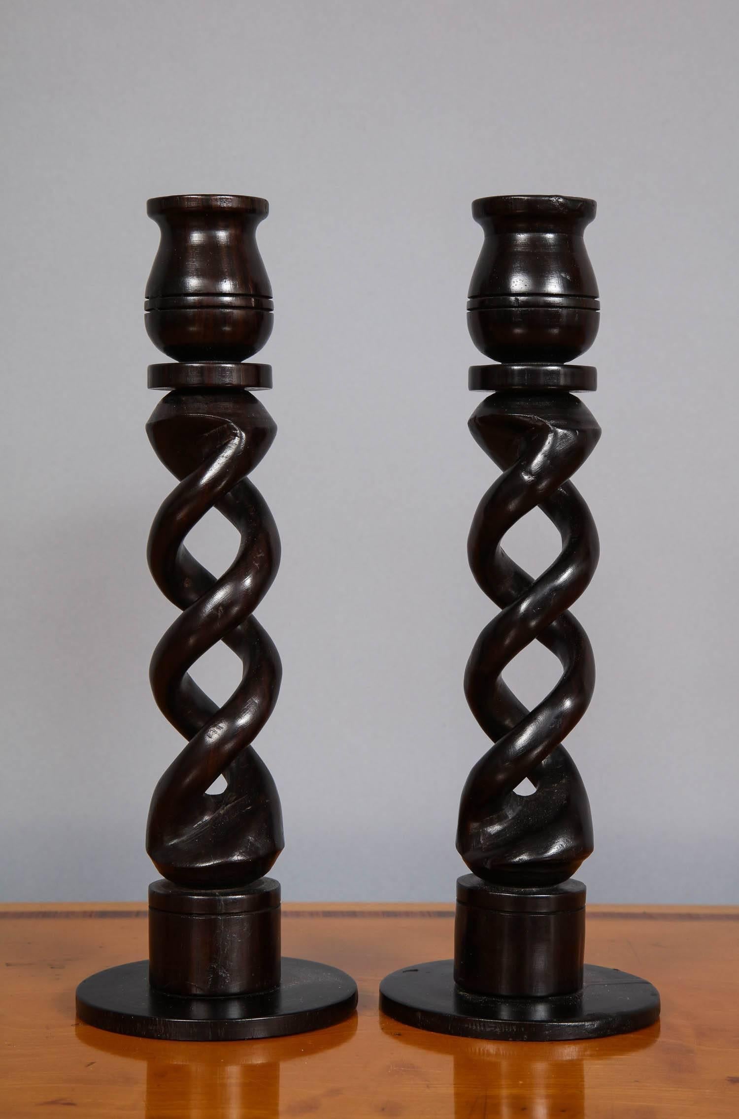 Good pair of Indian turned ebony candlesticks with open work barley twist shafts.