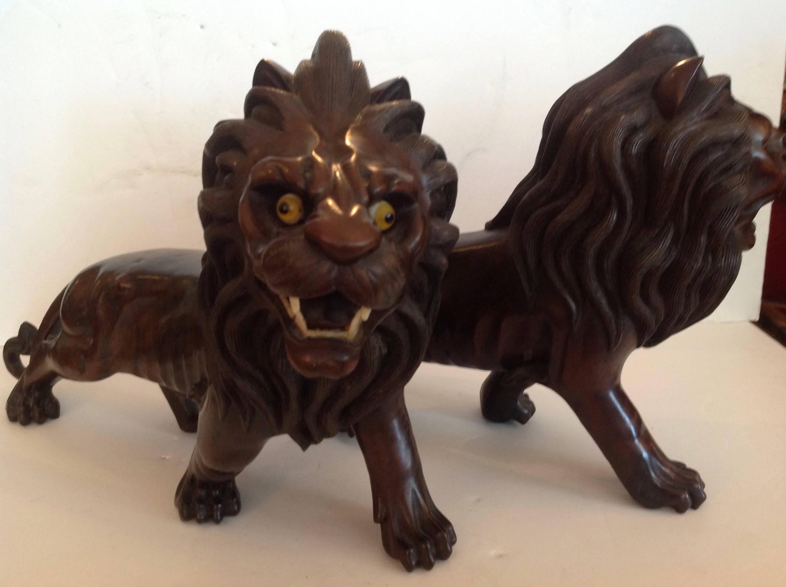 Hand-Carved Pair of Ebony Indo, Burmese Figures of Lions