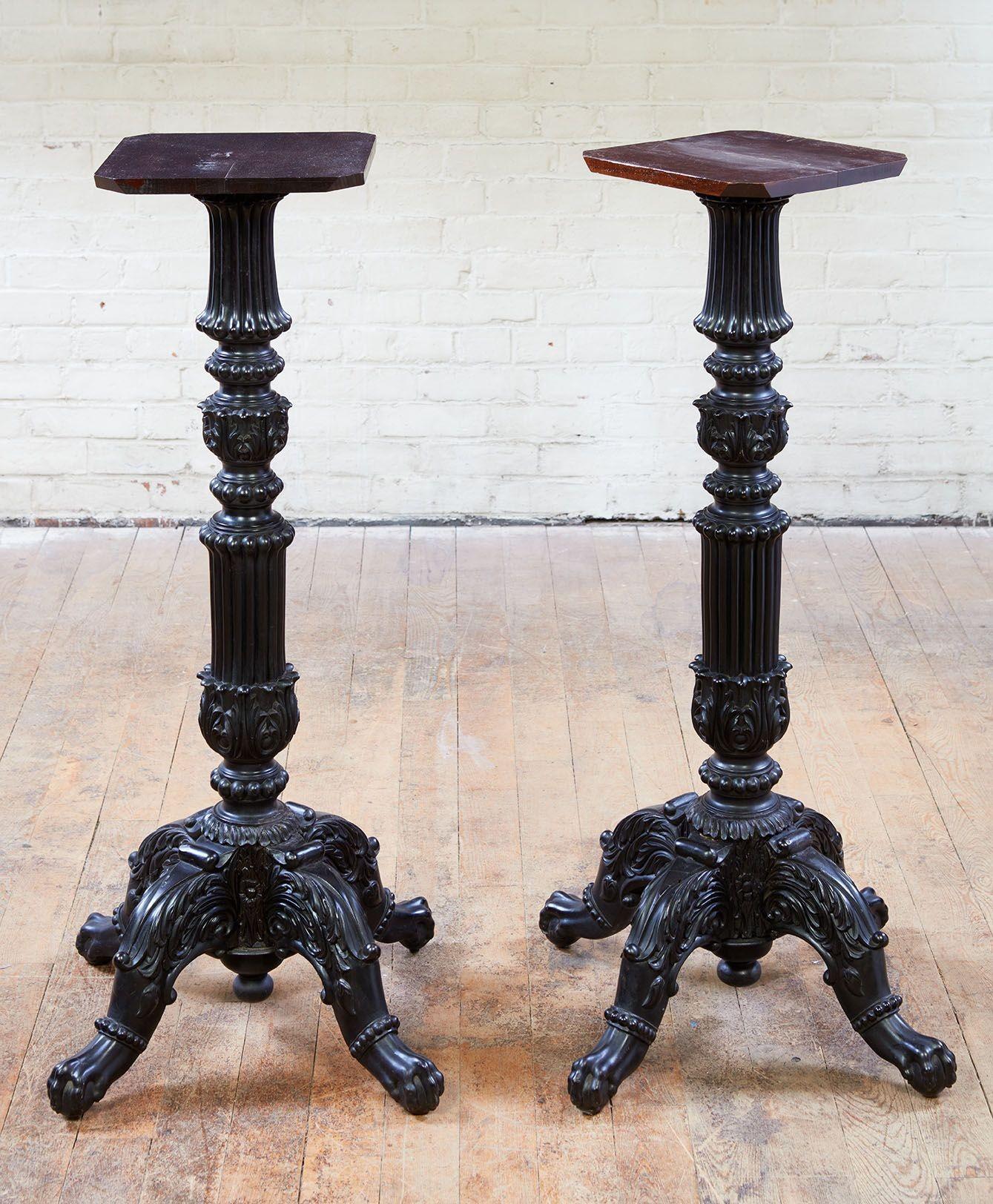 A fine pair of Anglo-Indian ebony pedestals, having circular marble tops over turned and profusely carved and ribbed columns, standing on four acanthus carved cabriole legs ending in lion paw feet. Ceylon, circa 1830.
