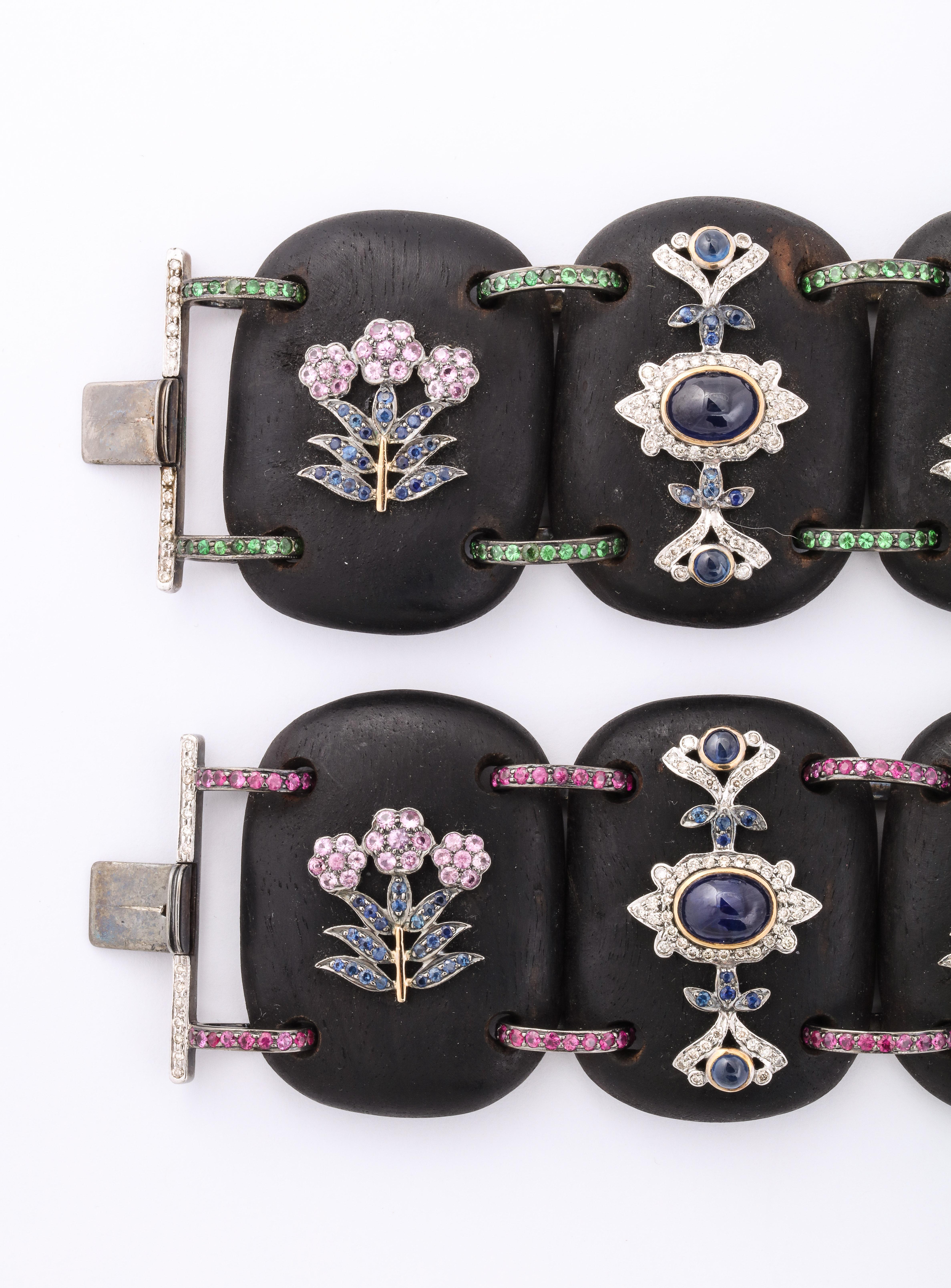 Pair of ebony, diamond, sapphire, ruby, tourmaline, emerald and citrine bracelets.  Oxidized silver, 146 grams, with 310 single cut diamonds at 1.5 carats. 7 1/2 inches long by 1 5/8 inches wide x 1/4 inch high.

Materials:
Oxidized silver, 146