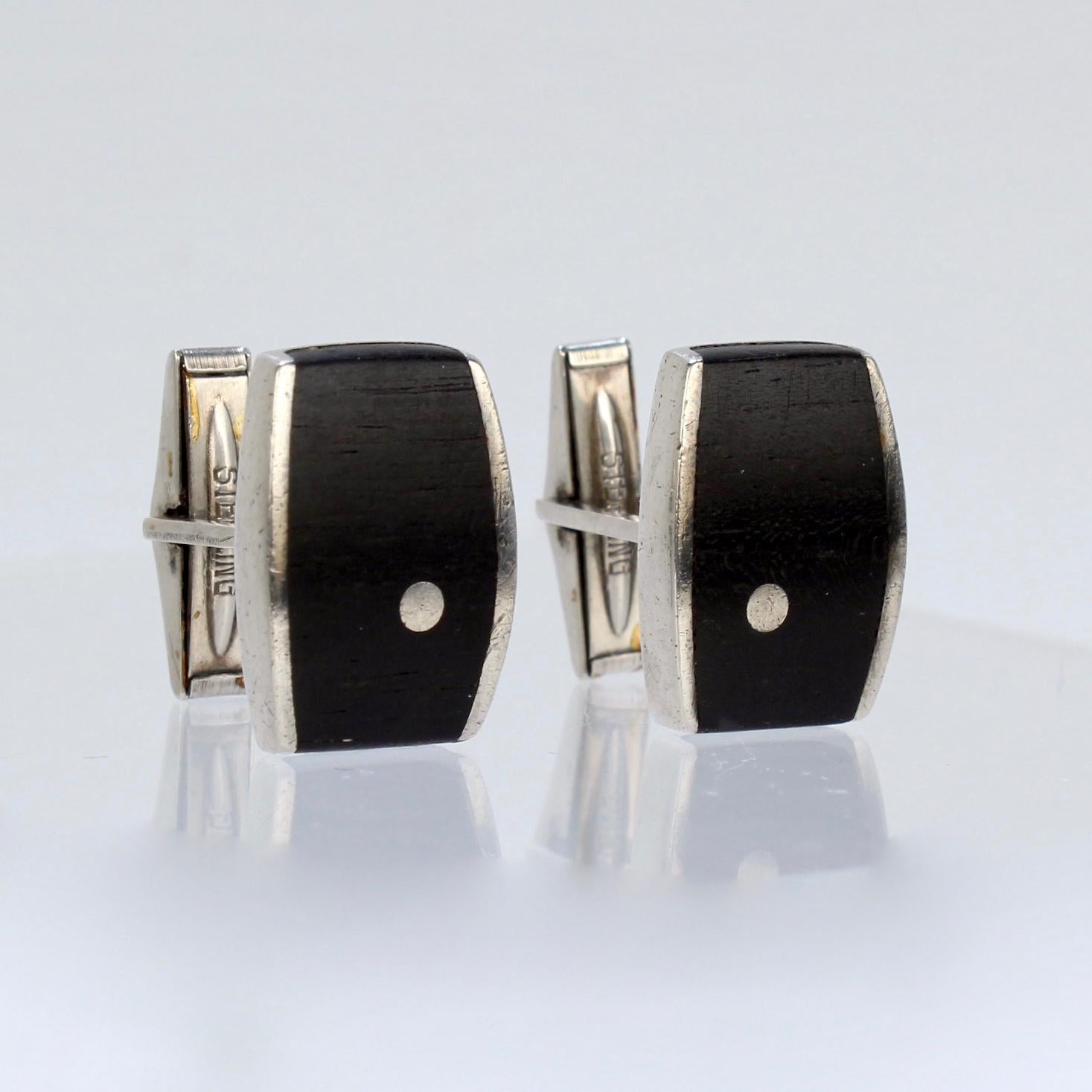 A superb pair of Ed Wiener cufflinks.

In sterling silver with inlaid ebony wood.

Marked: Sterling for silver fineness and Ed Wiener.

Great cufflinks from the renowned New York modernist jewelry maker!

Height: ca. 24mm
Width: ca. 15mm

Items