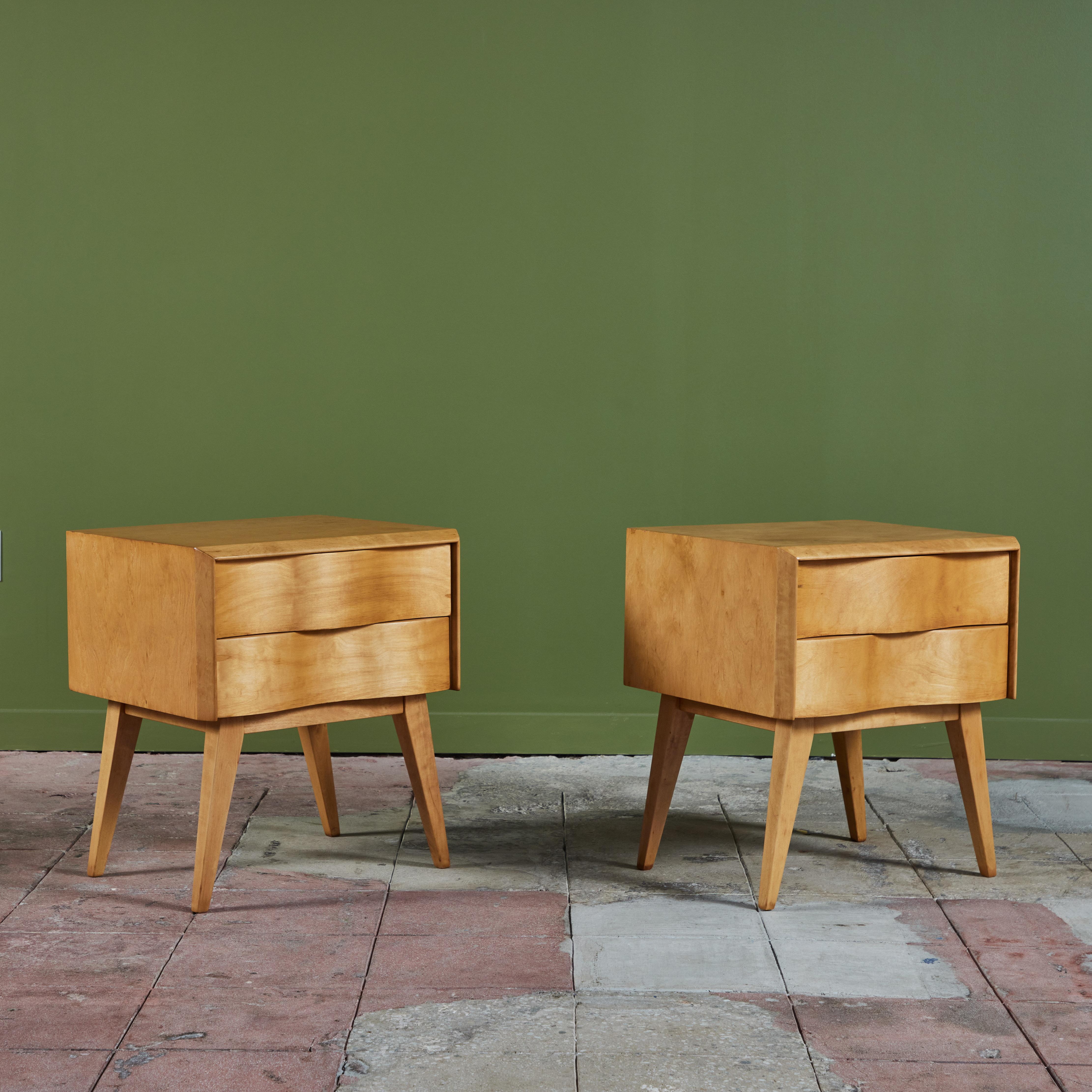 Pair of nightstands by Edmond Spence, c.1950s, Sweden. The maple nightstands feature two drawers with a unique sculpted wave front design. The stands rest on four splayed legs.

Dimensions
21