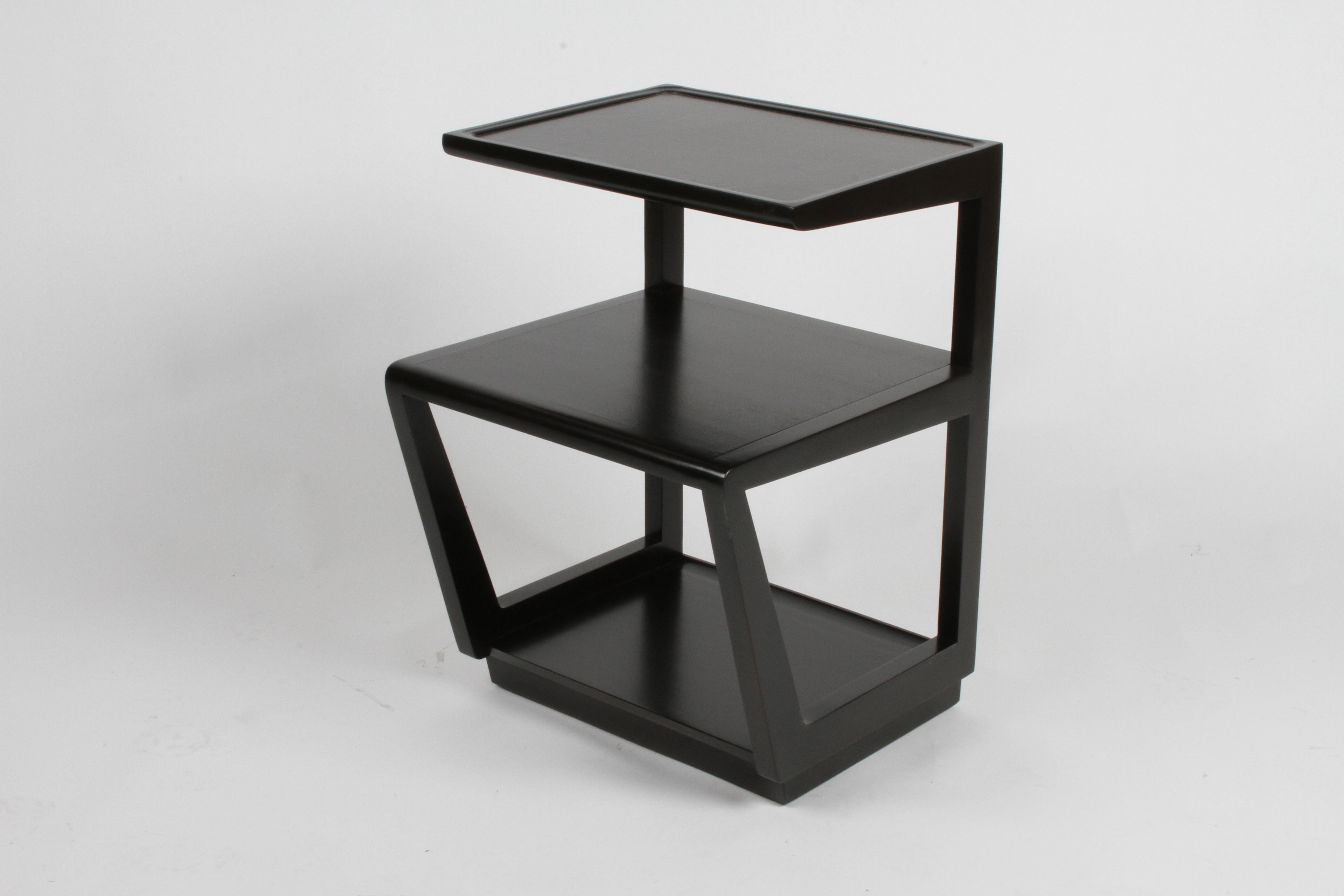 Pair of Drexel Precedent collection three-tiered end tables or nightstands designed by Edward Wormley, top shelf covered in leather, circa 1949. Silver elm is refinished in dark espresso. One table has the stencil to the underside, with
