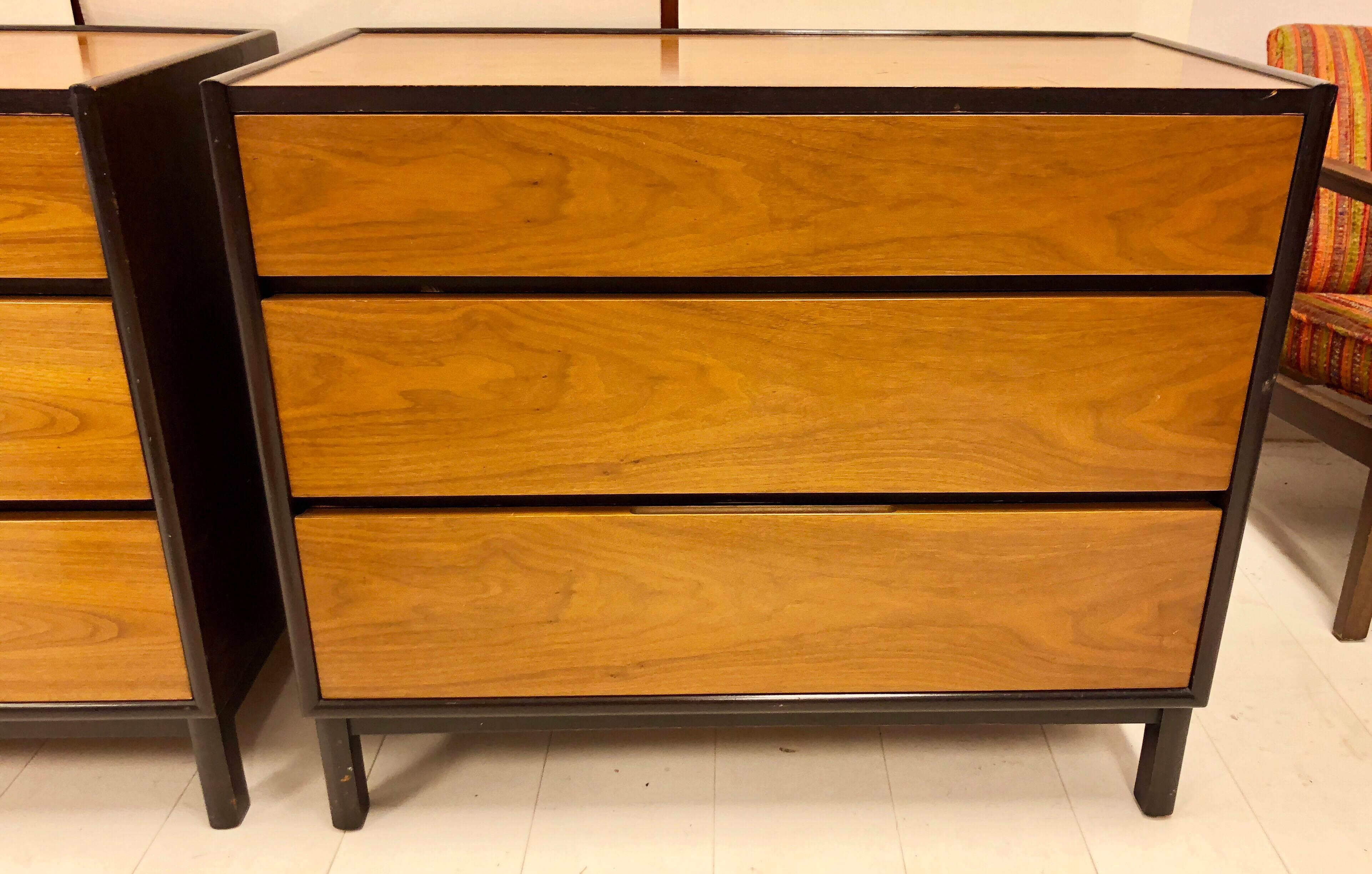 Handsome masculine chests of drawers in walnut with dark mahogany trim. Each chest retains its Dunbar gold metal tag.