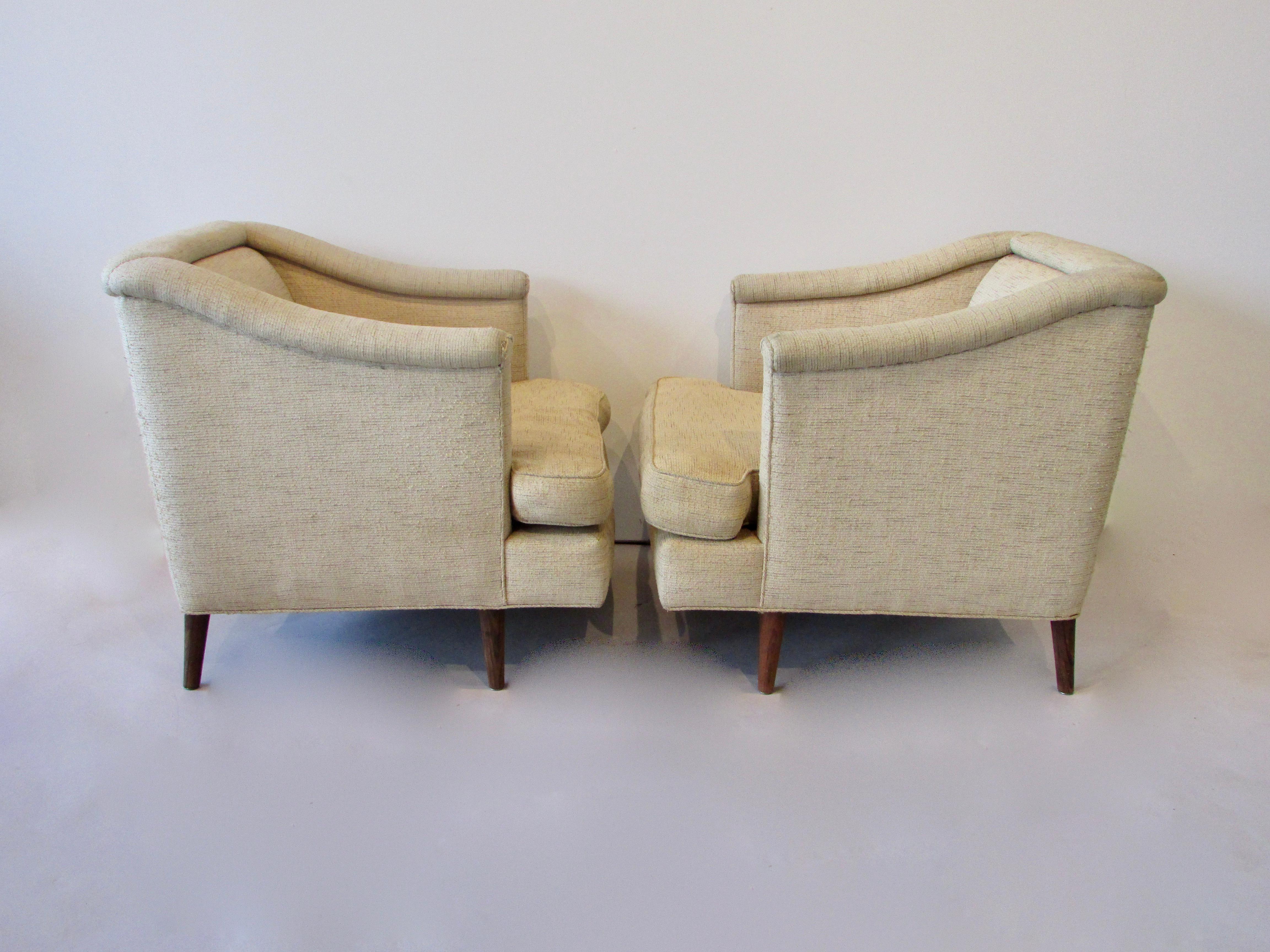 Iconic classic yet modernist styling of Edward Wormley for Dunbar furniture. Pair of chairs in original fabric with Dunbar for moderns label intact. I am showing these in as found condition for the benefit of clients own textile clients. This keeps