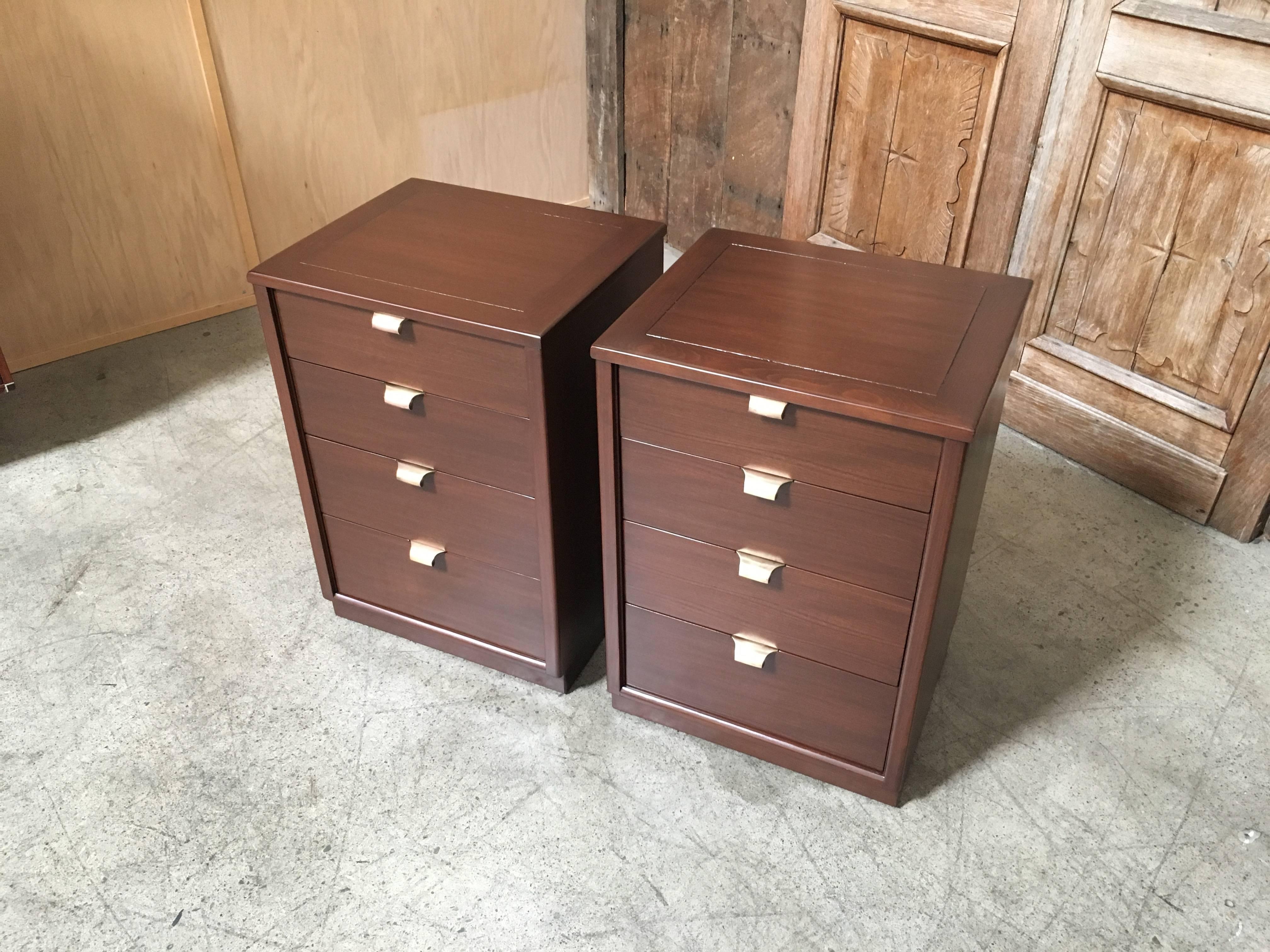 Great pair of precedent nightstands finished in a medium walnut with solid brass drawer pulls.