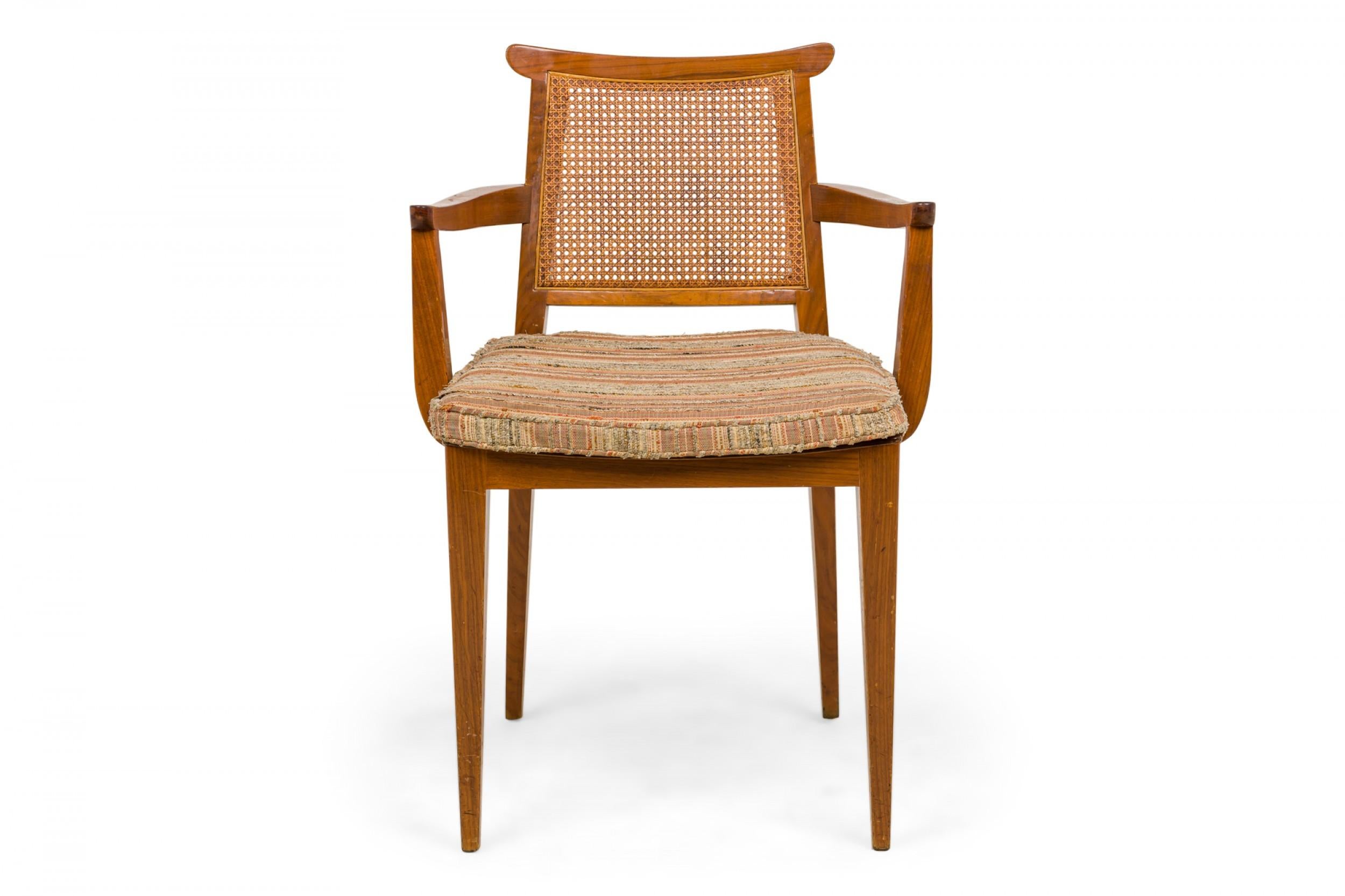 PAIR of American Mid-Century dining armchairs with wooden frames, woven striped beige, gray, and orange linen upholstered seats, and caned backs. (EDWARD WORMLEY FOR DUNBAR FURNITURE COMPANY)(PRICED AS SET).