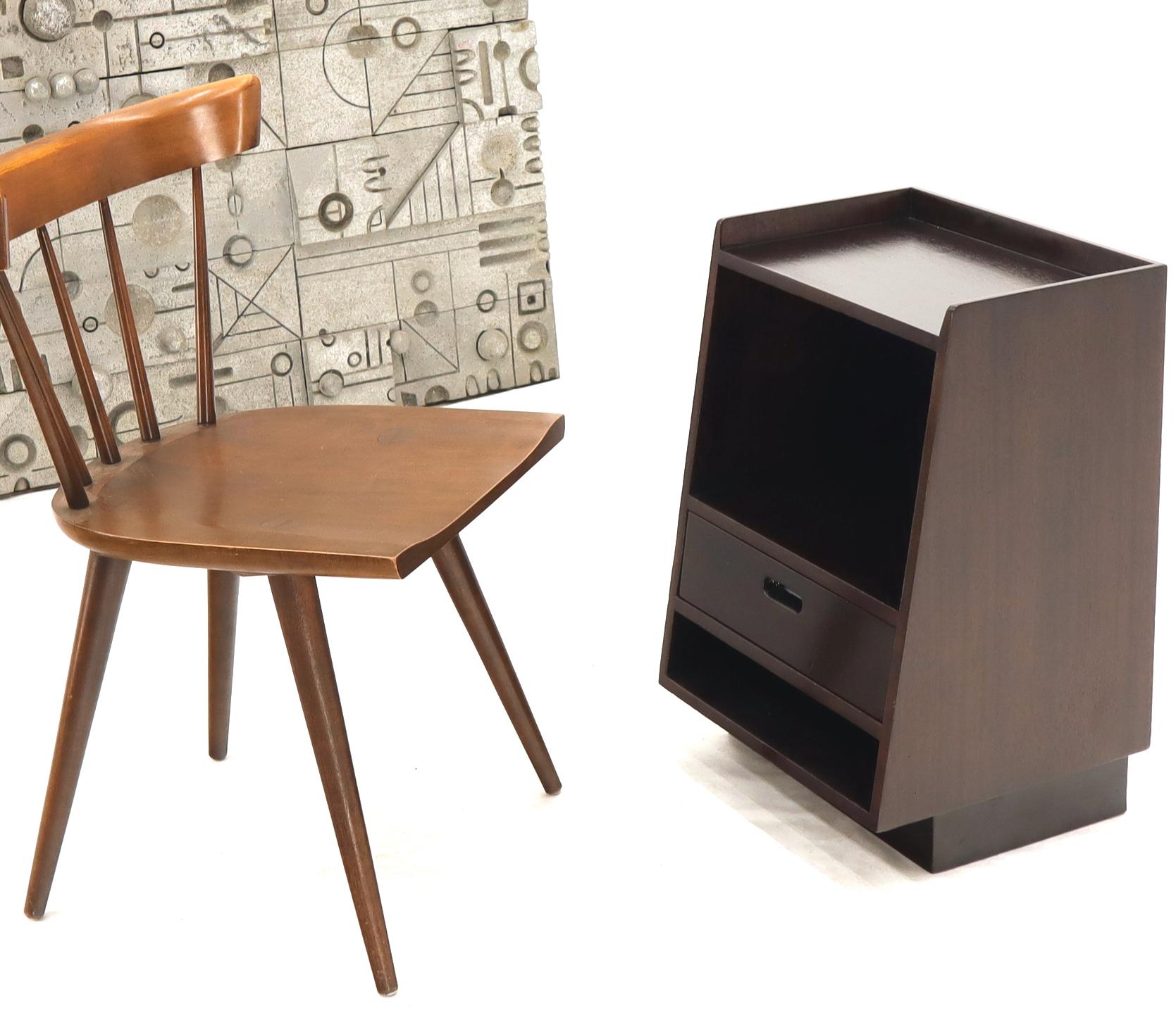 Pair if expresso finish mahogany nightstands by Edward Warmley for Dunbar on lacquered leather bases.