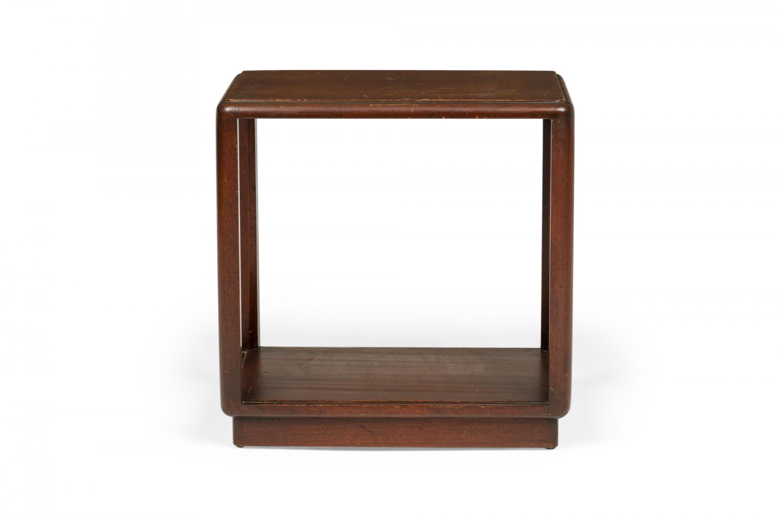 PAIR of American Mid-Century dark wood end / side tables with rectangular tops with rounded corners, pedestal bases, and an open frame design. (EDWARD WORMLEY FOR DUNBAR FURNITURE COMPANY)(PRICED AS PAIR).