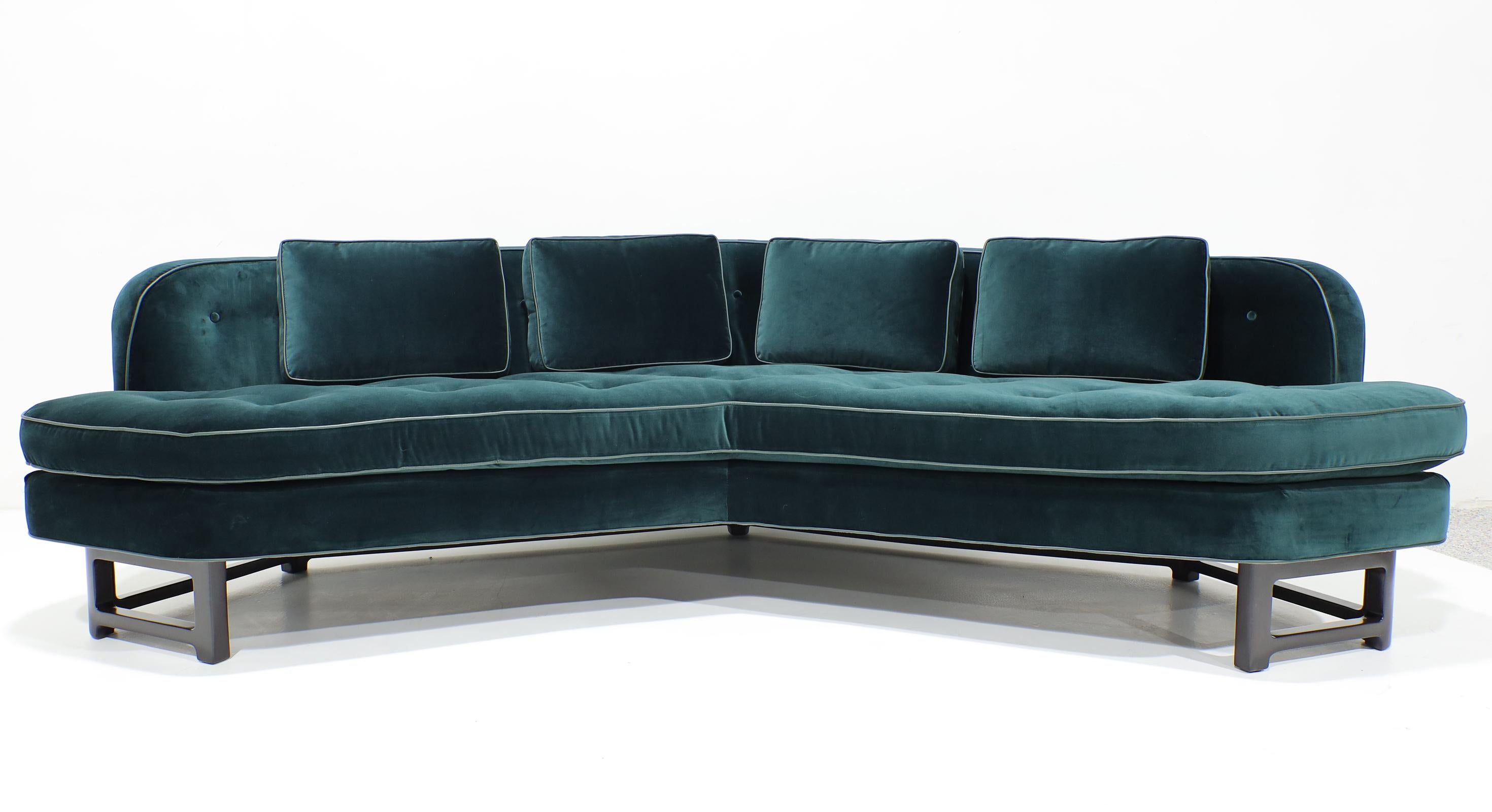 An outstanding pair of Edward Wormley for Dunbar Janus Model 6329 Angle sofas newly upholstered in a Raf Simons teal velvet with leather trim.  

Conceived in 1957, The Janus sofa was introduced in 1957 and is one of Edward Wormley's most iconic