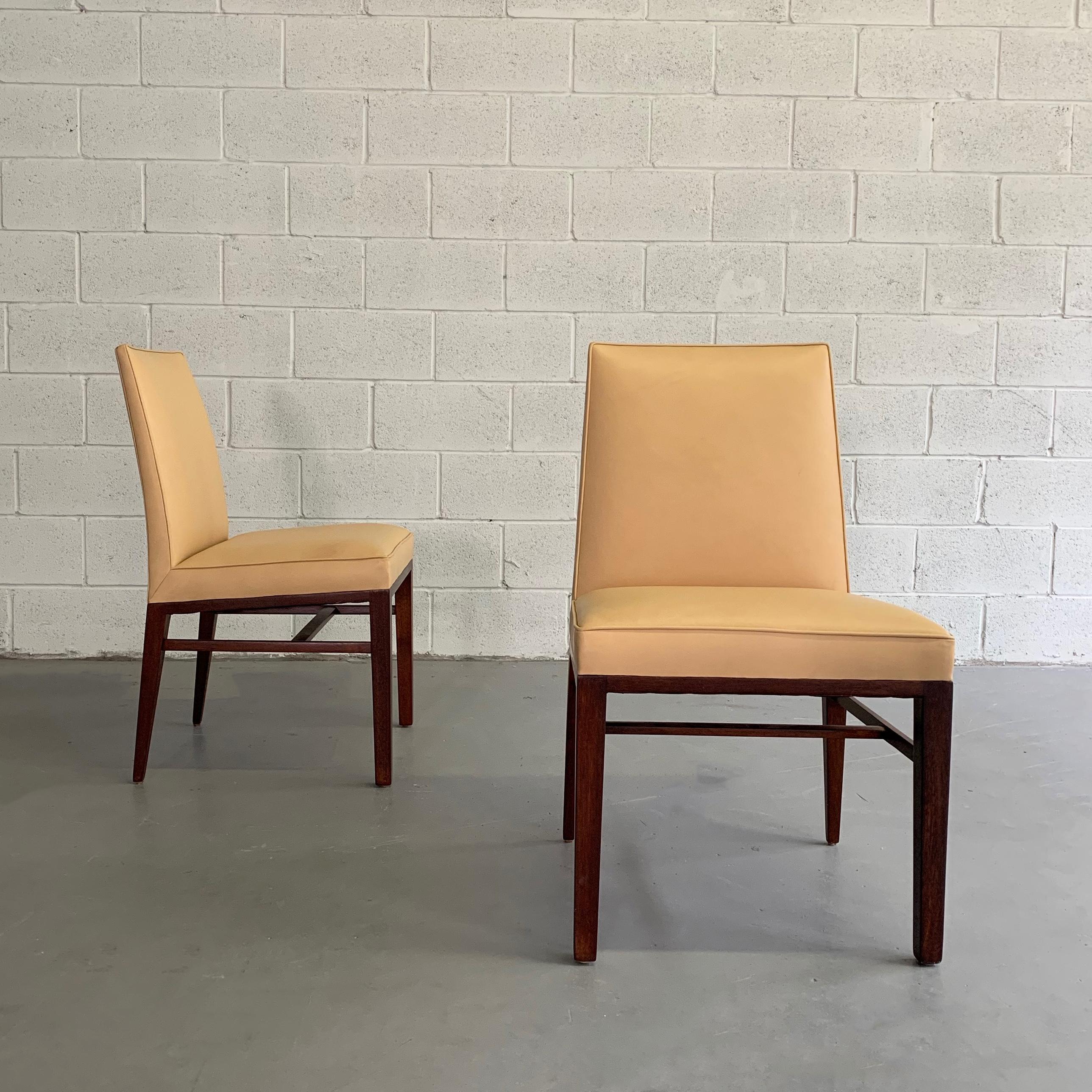 Pair of slipper, side chairs by Edward Wormley for Dunbar feature mahogany frames with high backs, upholstered in butterscotch leather.