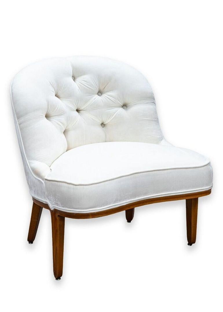A pair of Janus boucle slipper chairs by Edward Wormely for Dunbar Furniture. A lovely pair of white slipper chairs with a classic mid century design and a wonderful choice of materials. These chairs feature a bright white velvet tufted upholstery,