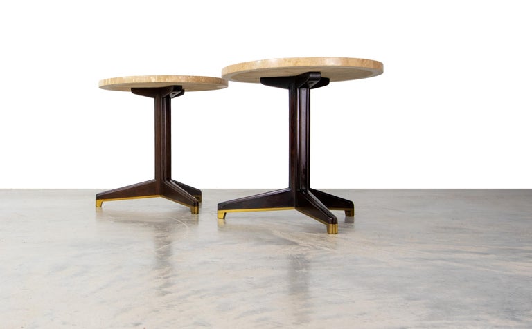 A pair of model 5928 tables consisting of travertine marble, solid mahogany, and a brass trimmed sabot. These tables rarely surface, and would make great end tables, beside tables or can even be grouped in front of a sofa or seating area. This table