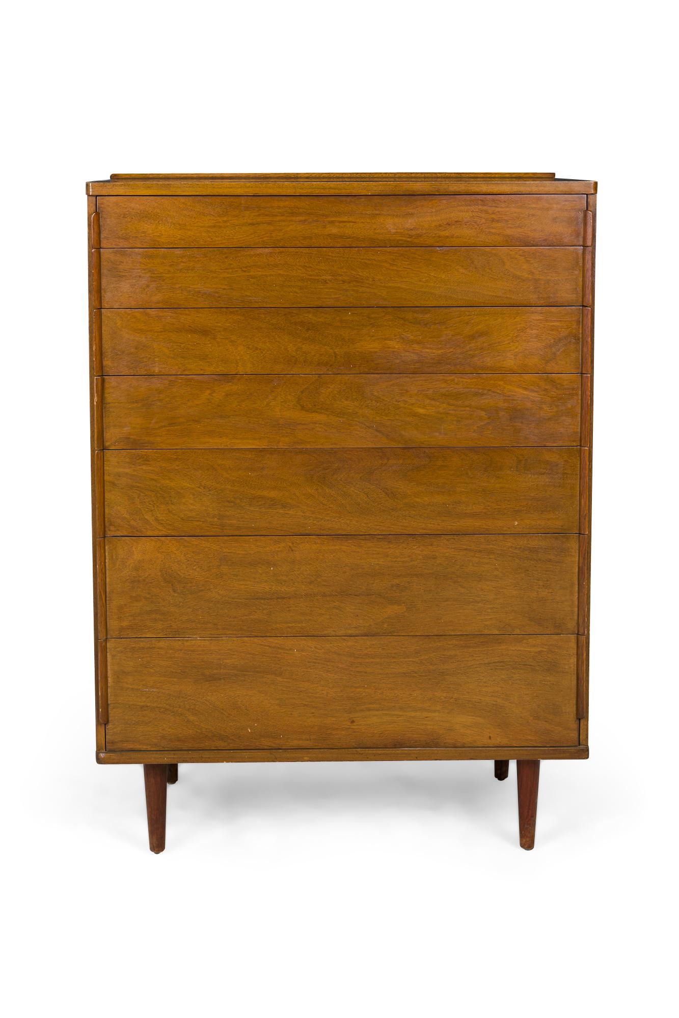 Pair of American mid-century 7-drawer chest with graduated drawer sizing, thin plywood drawer pulls on the sides of each drawer front, all in rosewood and walnut veneer, resting on four tapered rosewood dowel legs. (EDWARD WORMLEY FOR DUNBAR