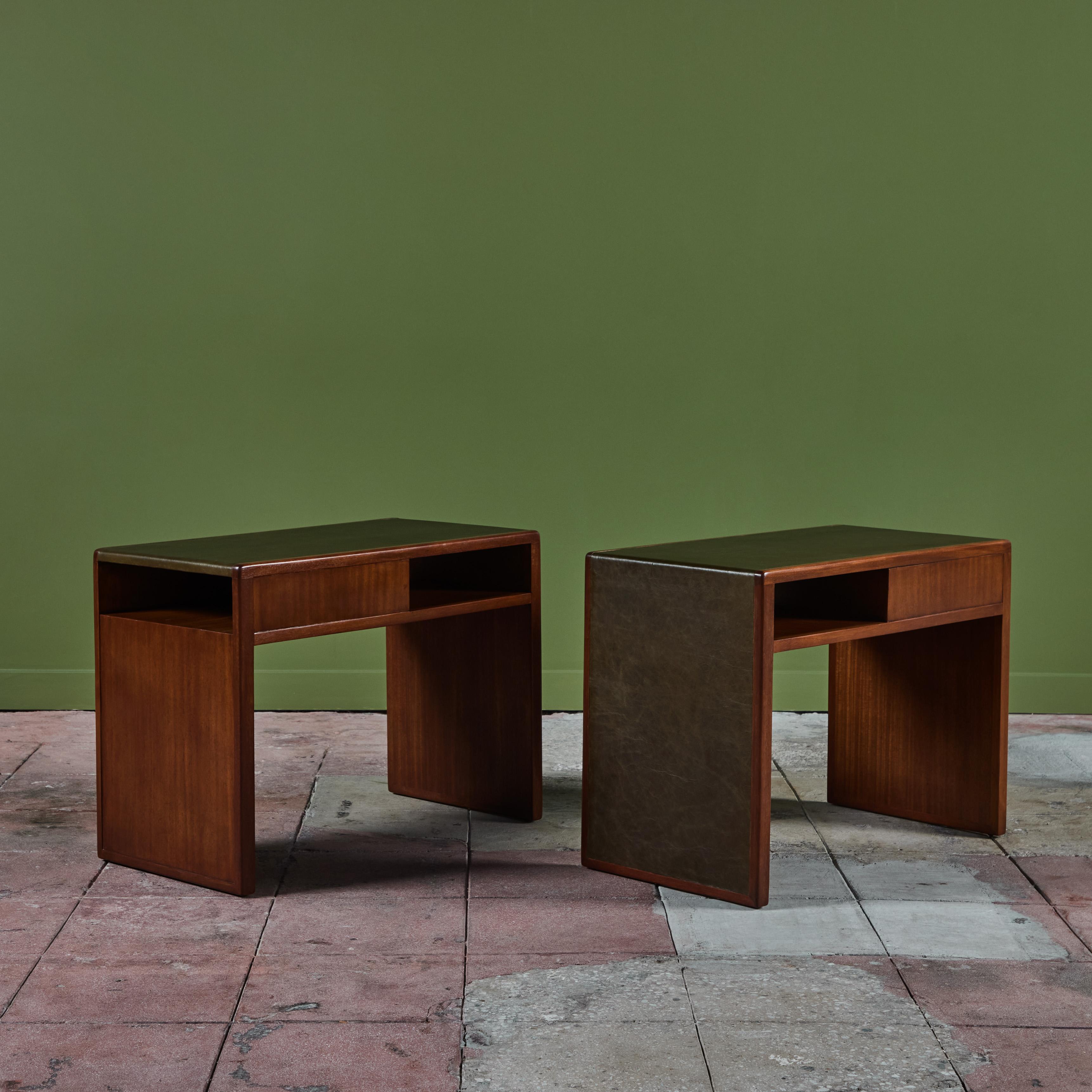 Pair of Edward Wormley Side Tables for Dunbar, c.1940, USA. The tables feature a mahogany waterfall style body with olive green leather table top that cascades down one side of each table. Each table has two petite shelves, one on the longer side