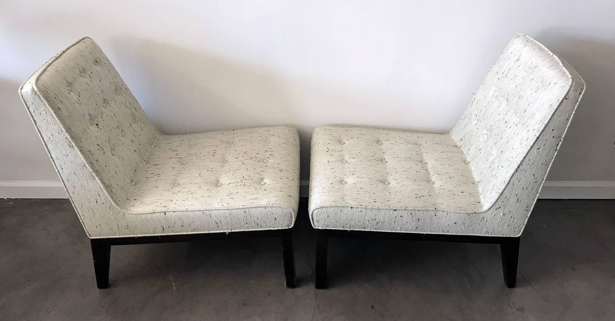 An absolutely stunning pair of slipper chairs by Edward Wormley for Dunbar! These vintage chairs have been freshly reupholstered in a new-old-stock nubby fabric that is a cream color with green flecks. The legs / framing of the chair has not been