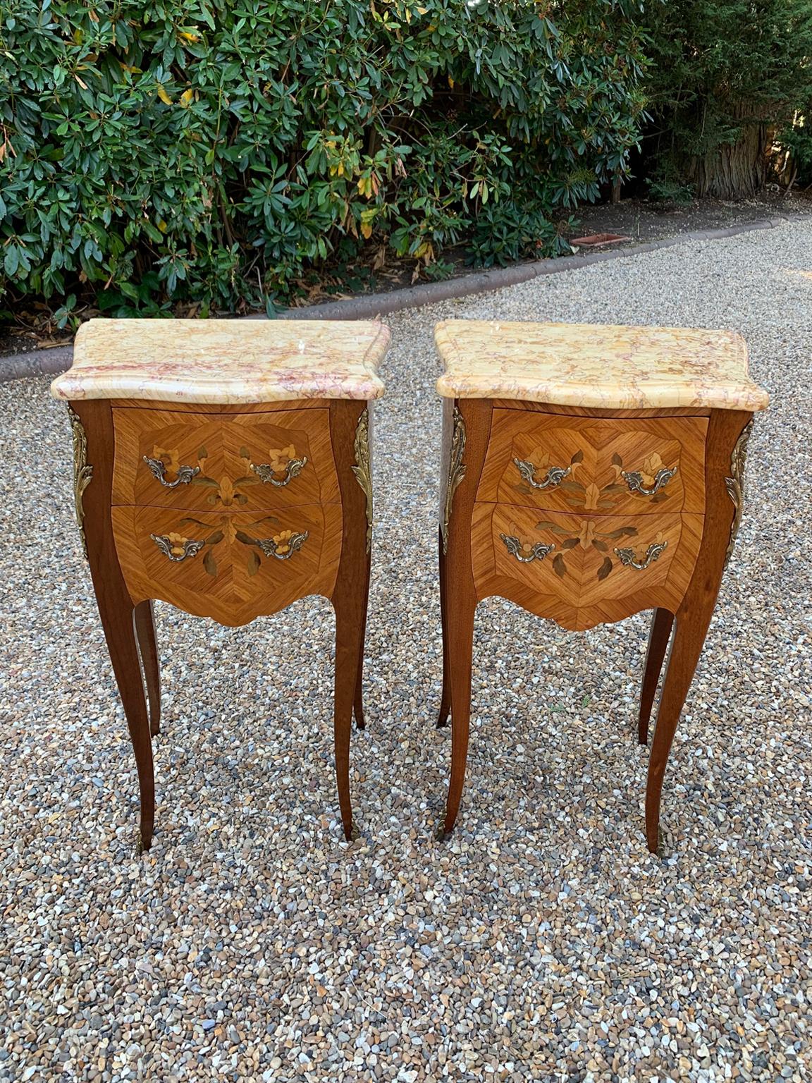 A Pair of Edwardian / 1920’s French Walnut & Kingwood floral inlaid Serpentine Bedsides of bombé form, each inset with a solid Marble Tops, above two fitted drawers and gilt metal mounts.

Circa: 1900 / 1920

Dimensions:
height: 30 inches – 76