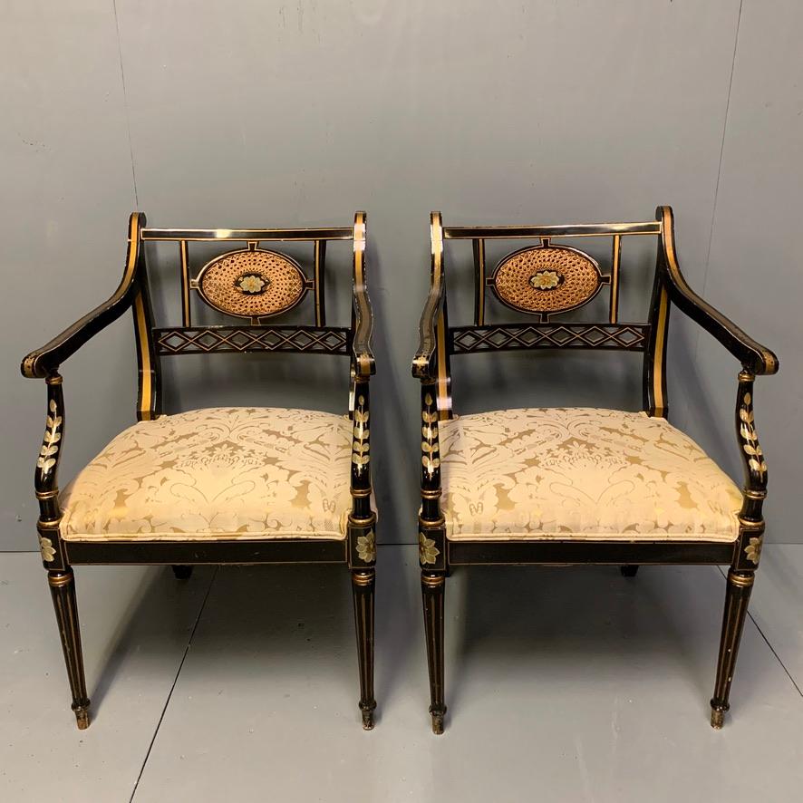 English Pair of Edwardian Black Lacquered and Gilt Highlighted Elbow Chairs with Cane