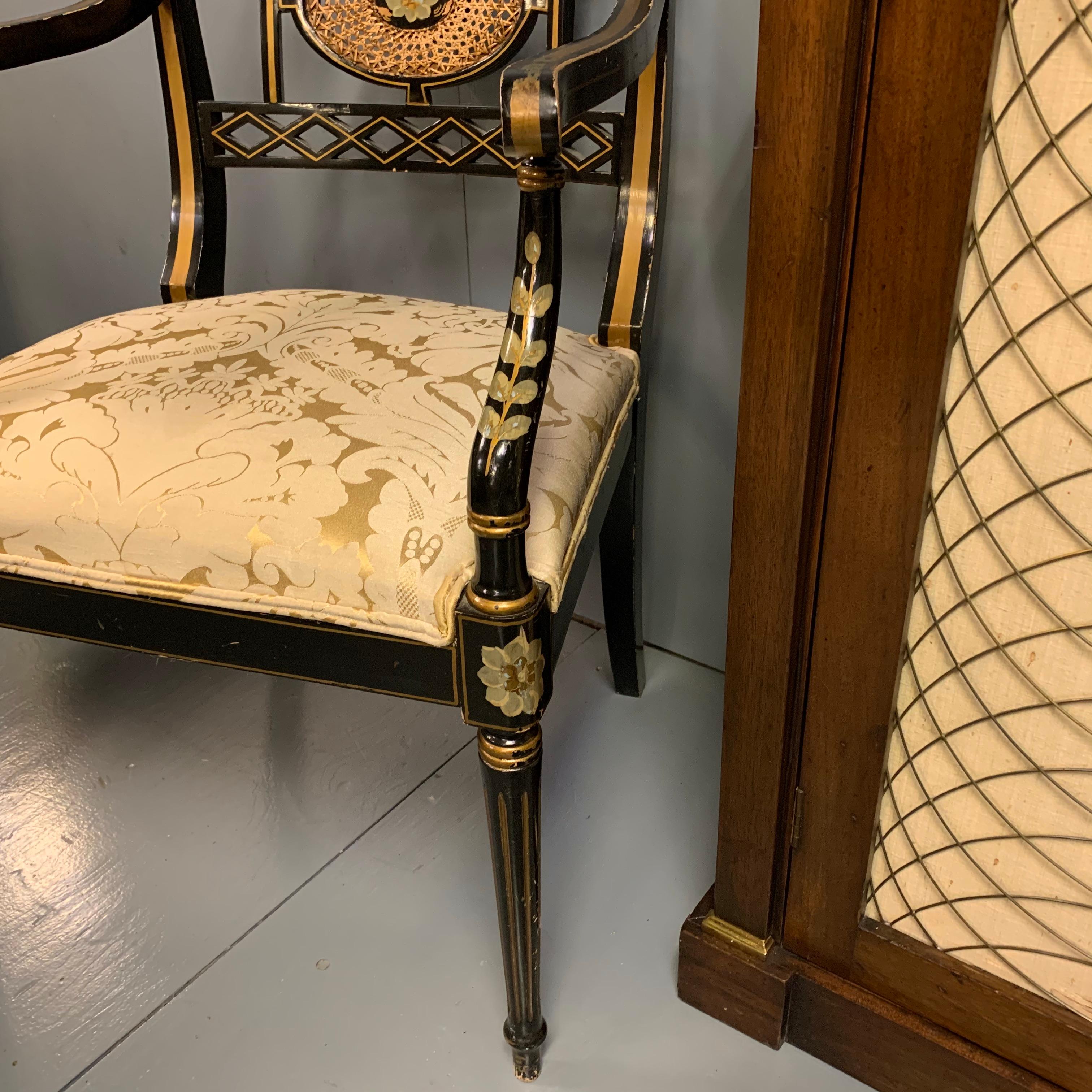 Pair of Edwardian Black Lacquered and Gilt Highlighted Elbow Chairs with Cane In Good Condition In Uppingham, Rutland